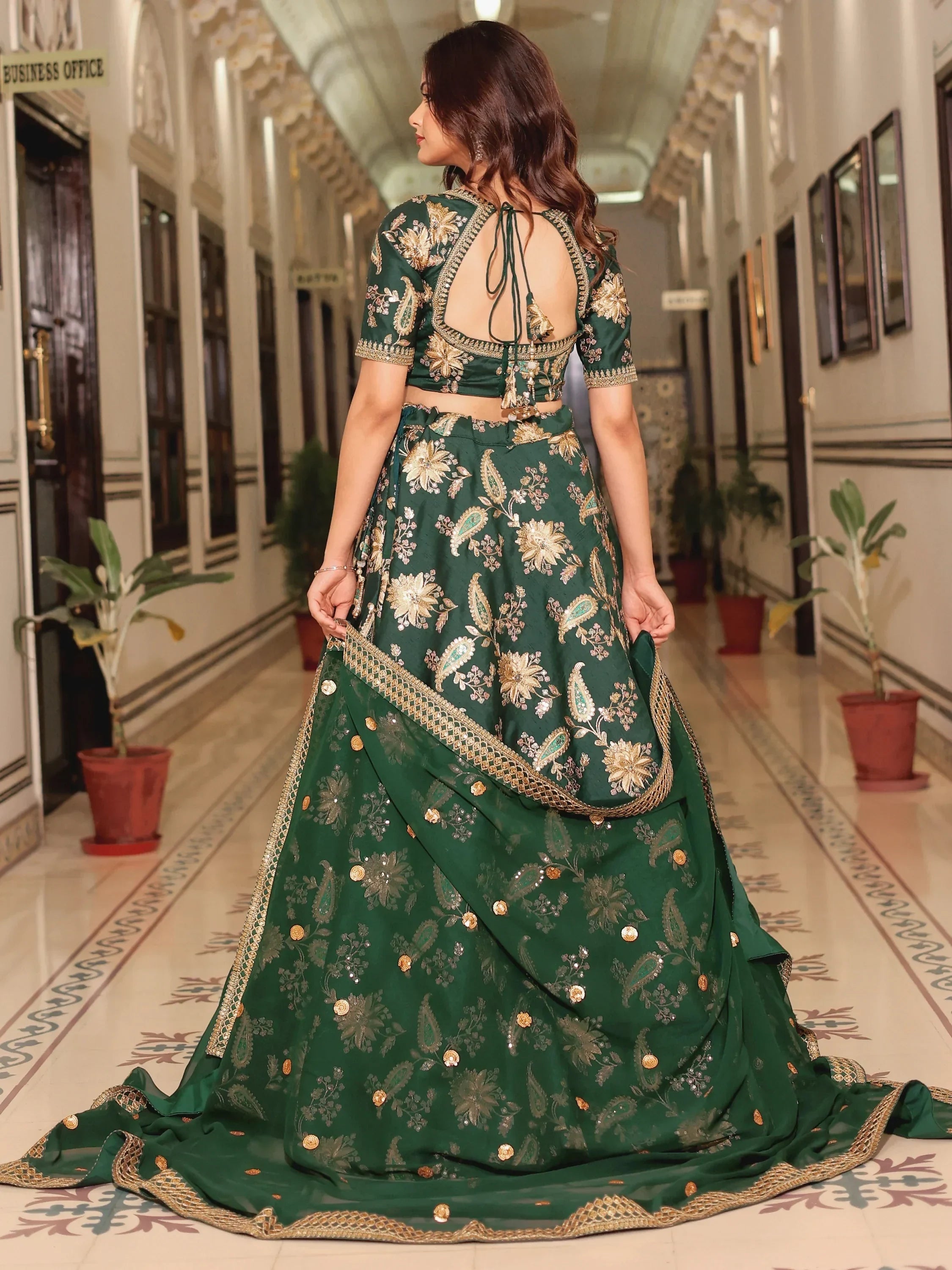 Emerald green lehenga choli with gold floral embroidery and back tie blouse, perfect for Indian weddings and festivals.
