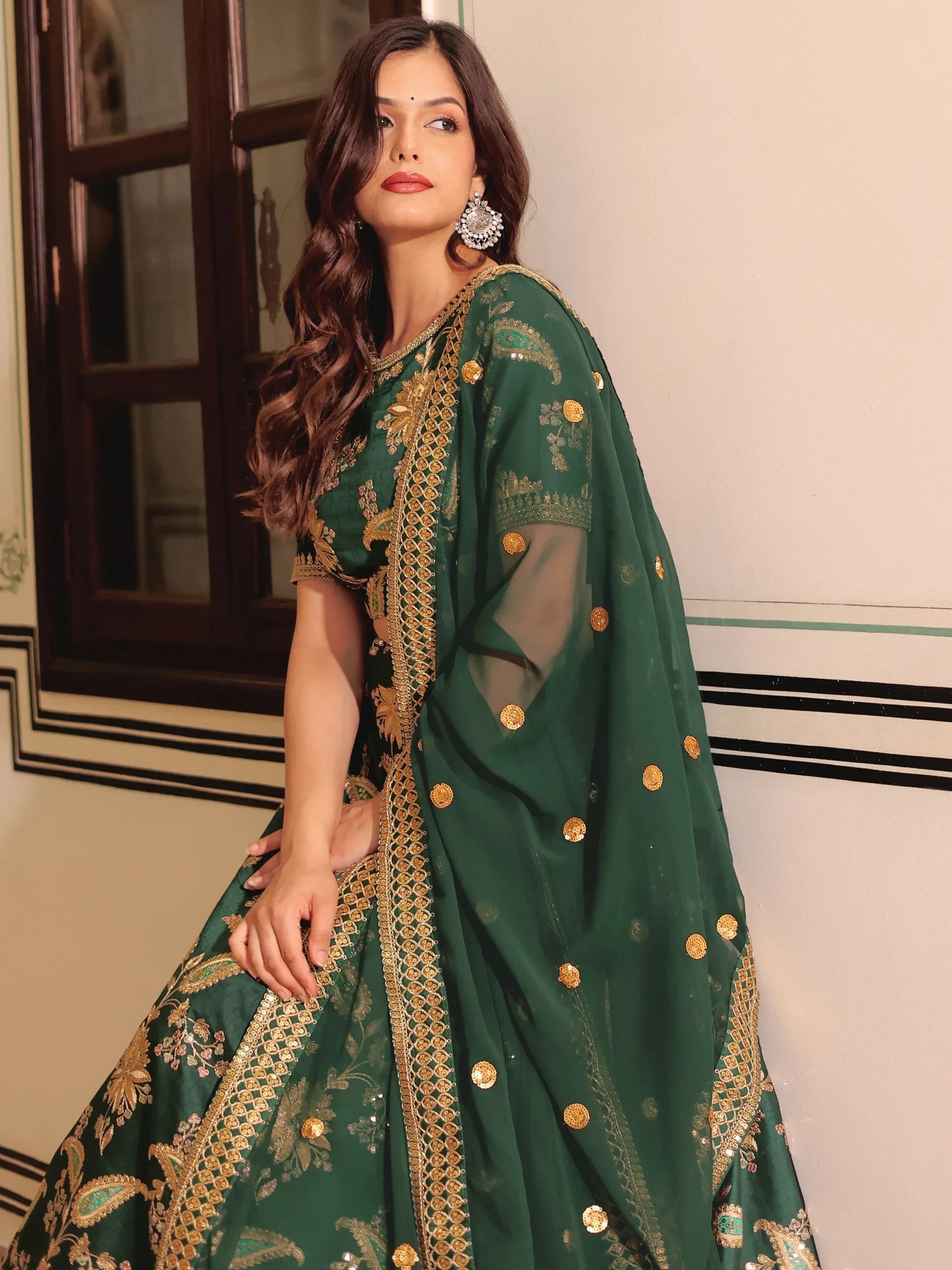 Emerald green lehenga choli with gold embroidery and sequins, perfect for Indian ethnic wear occasions.