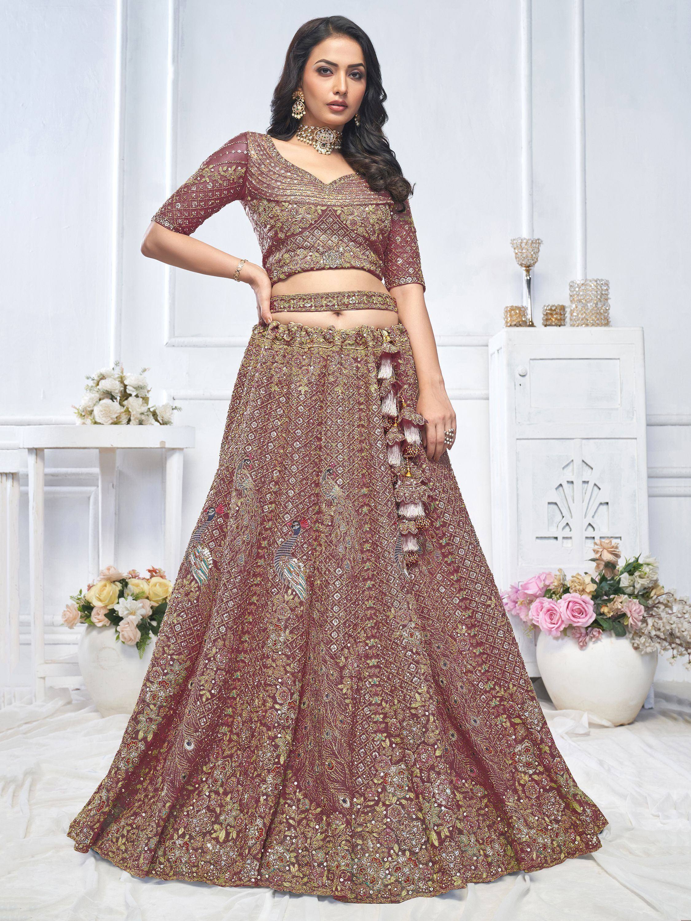 Maroon embroidered lehenga choli with peacock motifs and tassels, perfect for Indian weddings and festive occasions