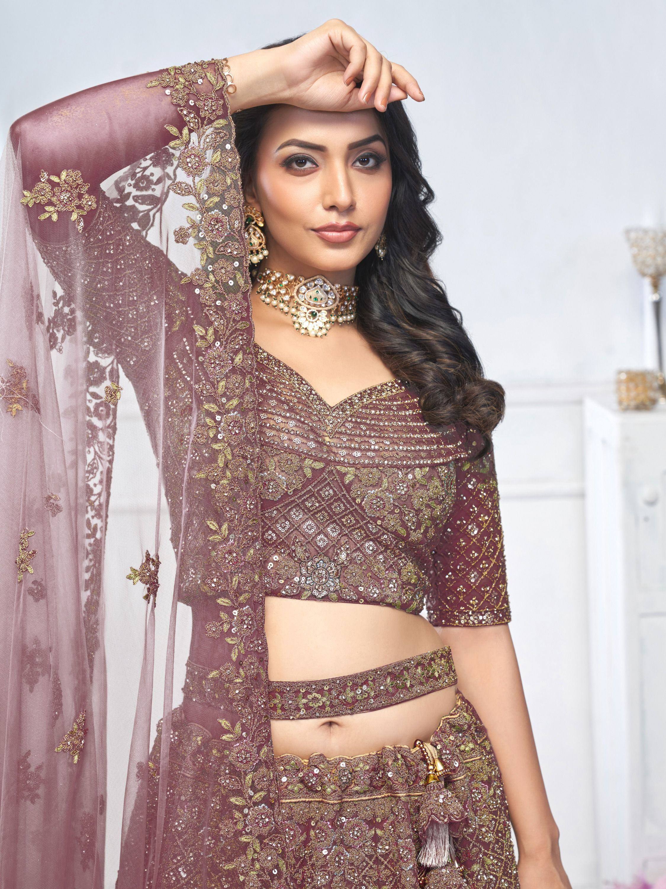Elegant maroon lehenga choli with gold embroidery and sequins, perfect for Indian weddings and festive occasions.