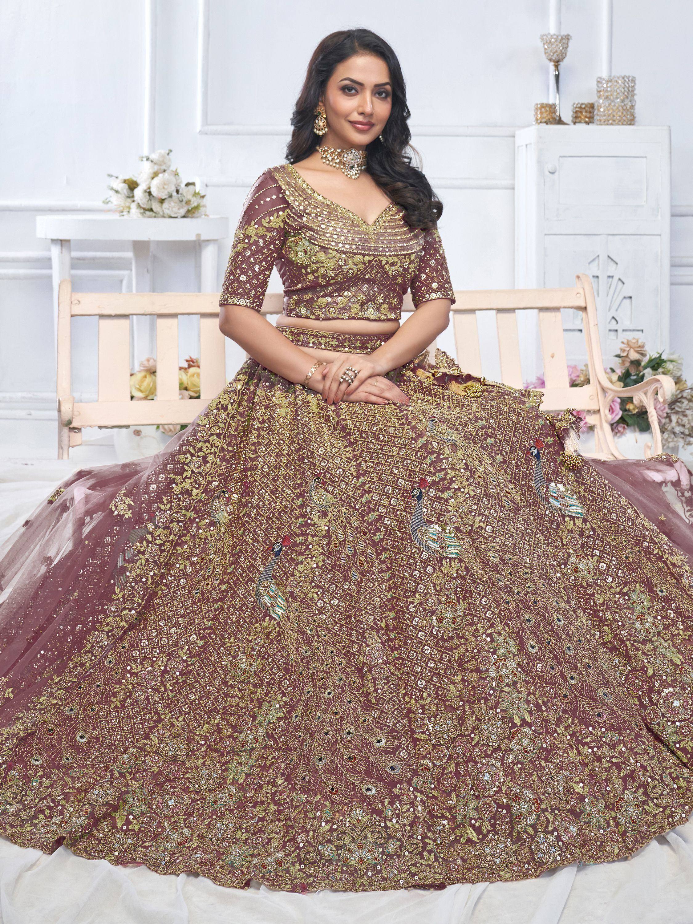 Elegant maroon lehenga choli with gold embroidery and peacock motifs, perfect for Indian weddings and festive occasions.
