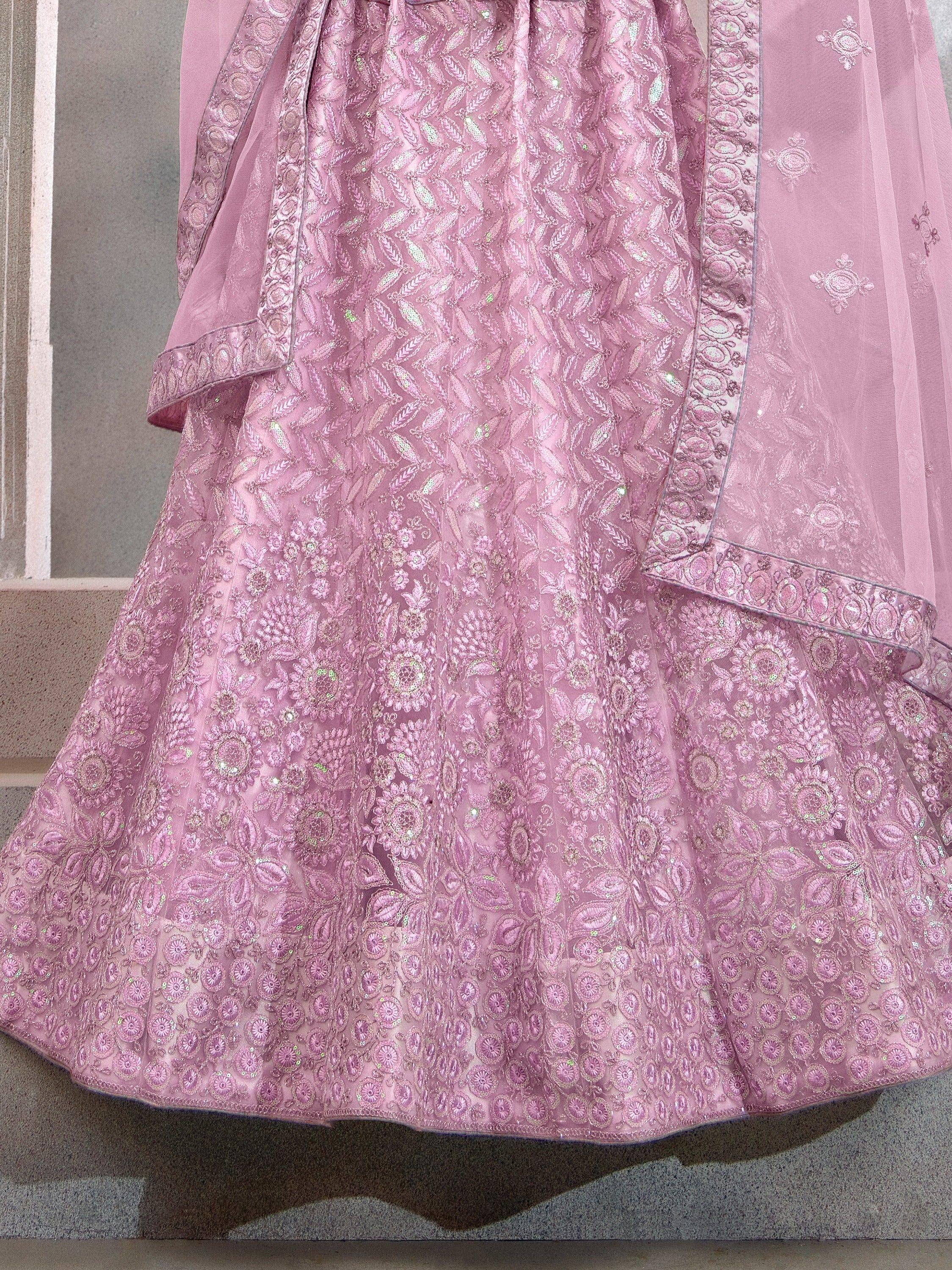 Pink designer lehenga choli with intricate floral embroidery and shimmering details, perfect for ethnic occasions.