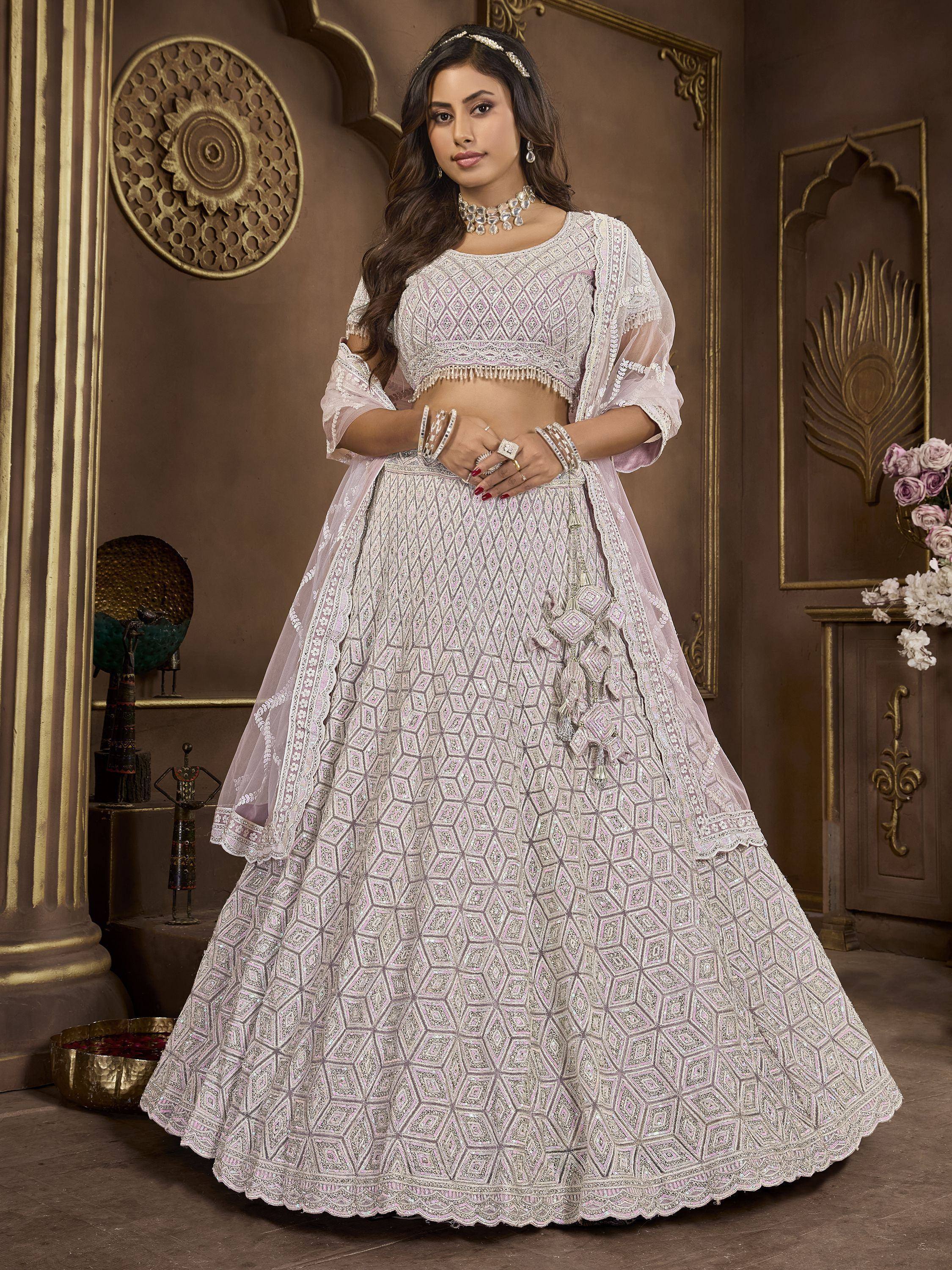 Elegant white and pink embroidered lehenga choli with geometric patterns, perfect for Indian weddings and festive occasions.