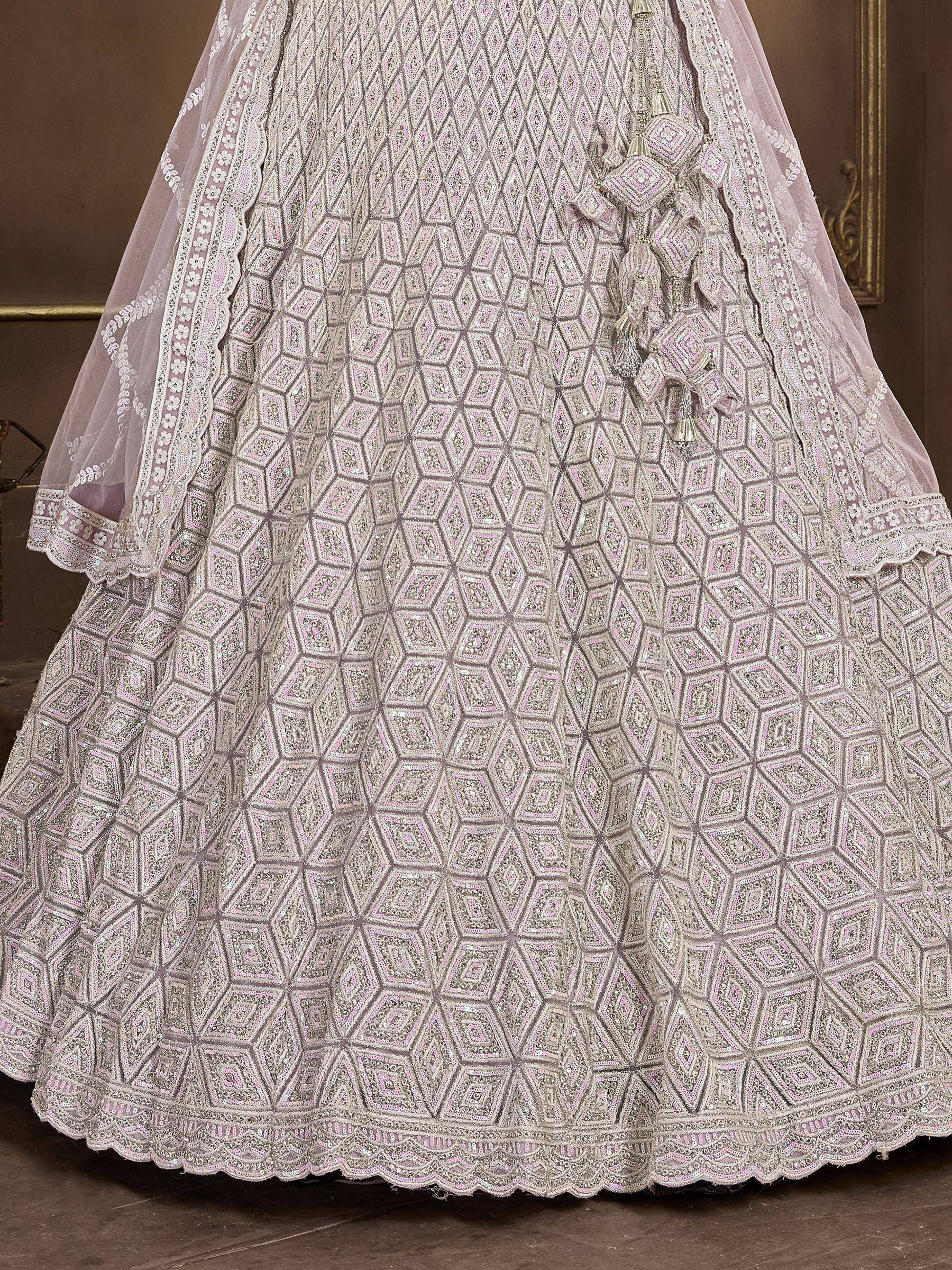 Elegant pink lehenga choli with geometric embroidery and tassel details, perfect for Indian weddings