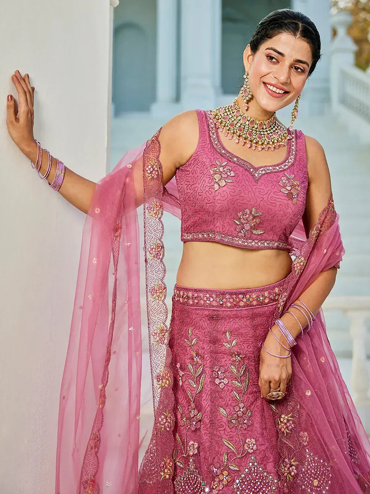 Pink embroidered lehenga choli with floral motifs and matching dupatta, perfect for Indian ethnic wear occasions