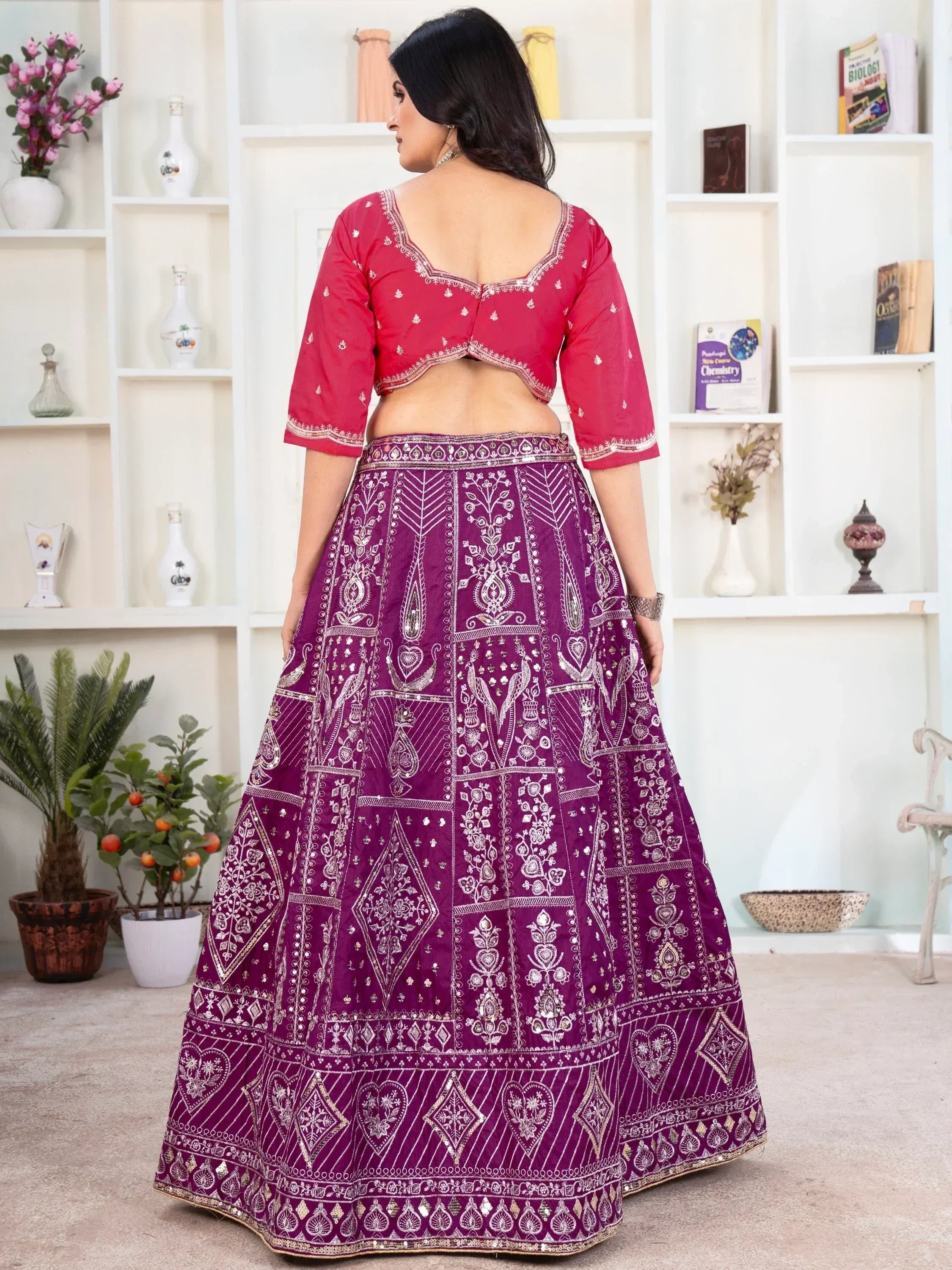 Woman in gold and purple designer lehenga choli with floral dupatta, ethnic Indian wear