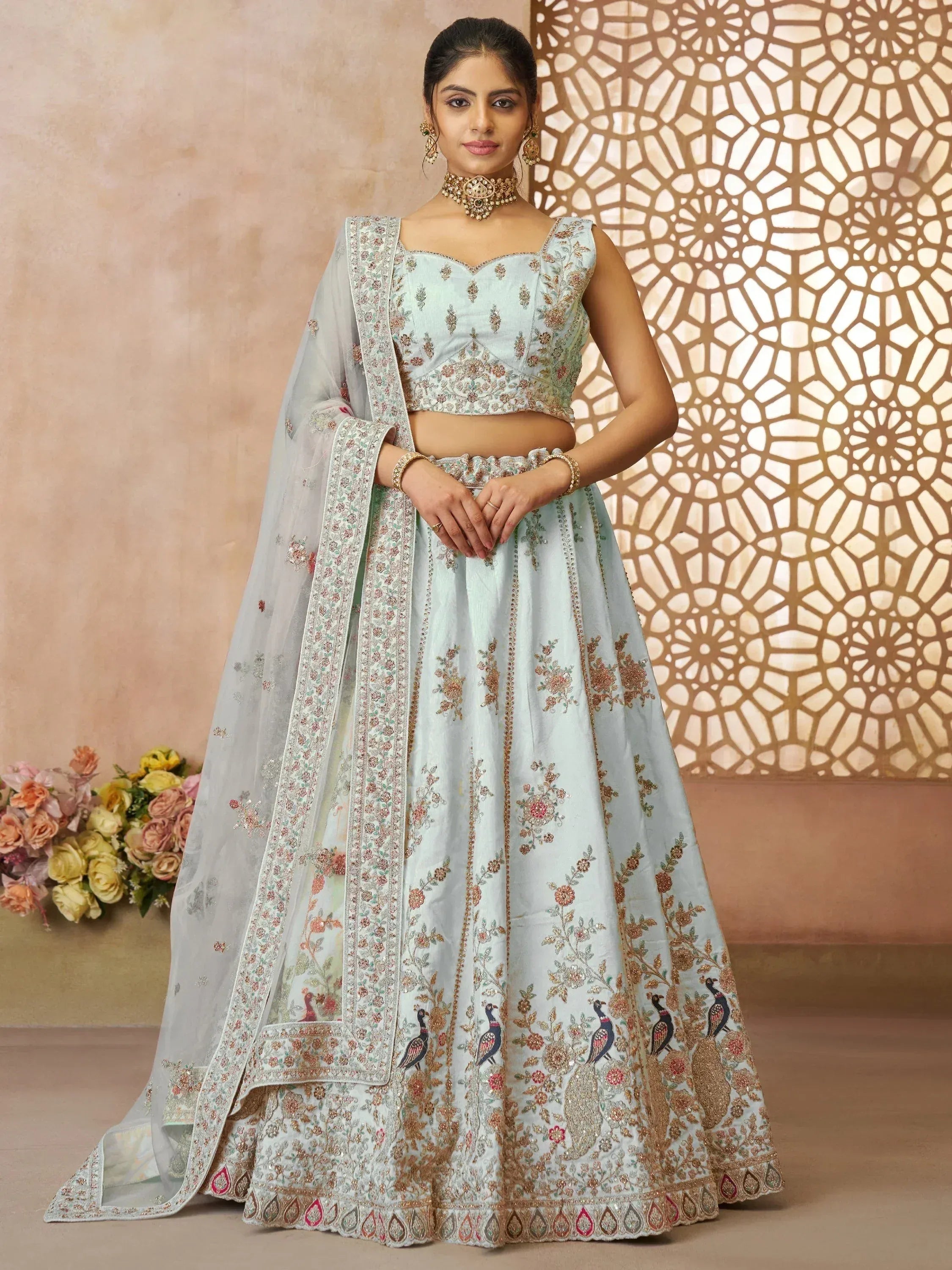 Light blue embroidered lehenga choli with peacock motifs, perfect for Indian weddings and festive occasions.