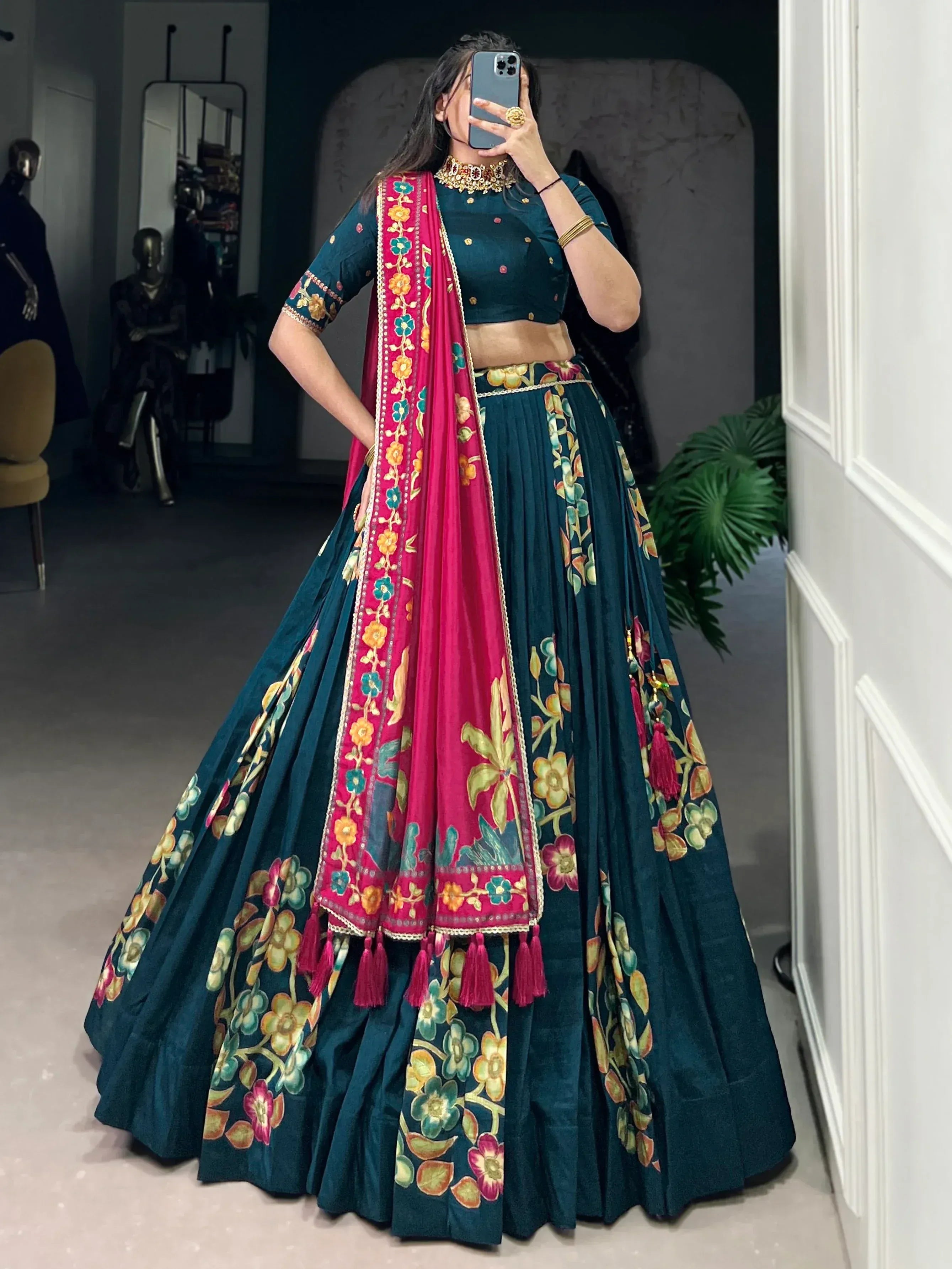 Teal floral lehenga choli with pink dupatta, perfect for Indian weddings and festive occasions.