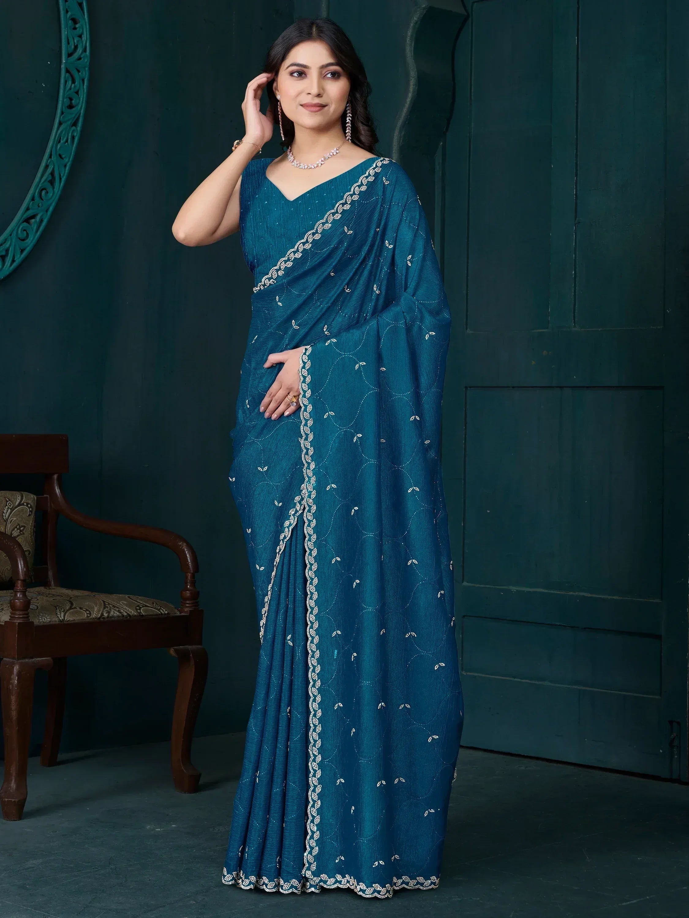 Teal blue embroidered saree with white detailing, perfect for Indian ethnic occasions