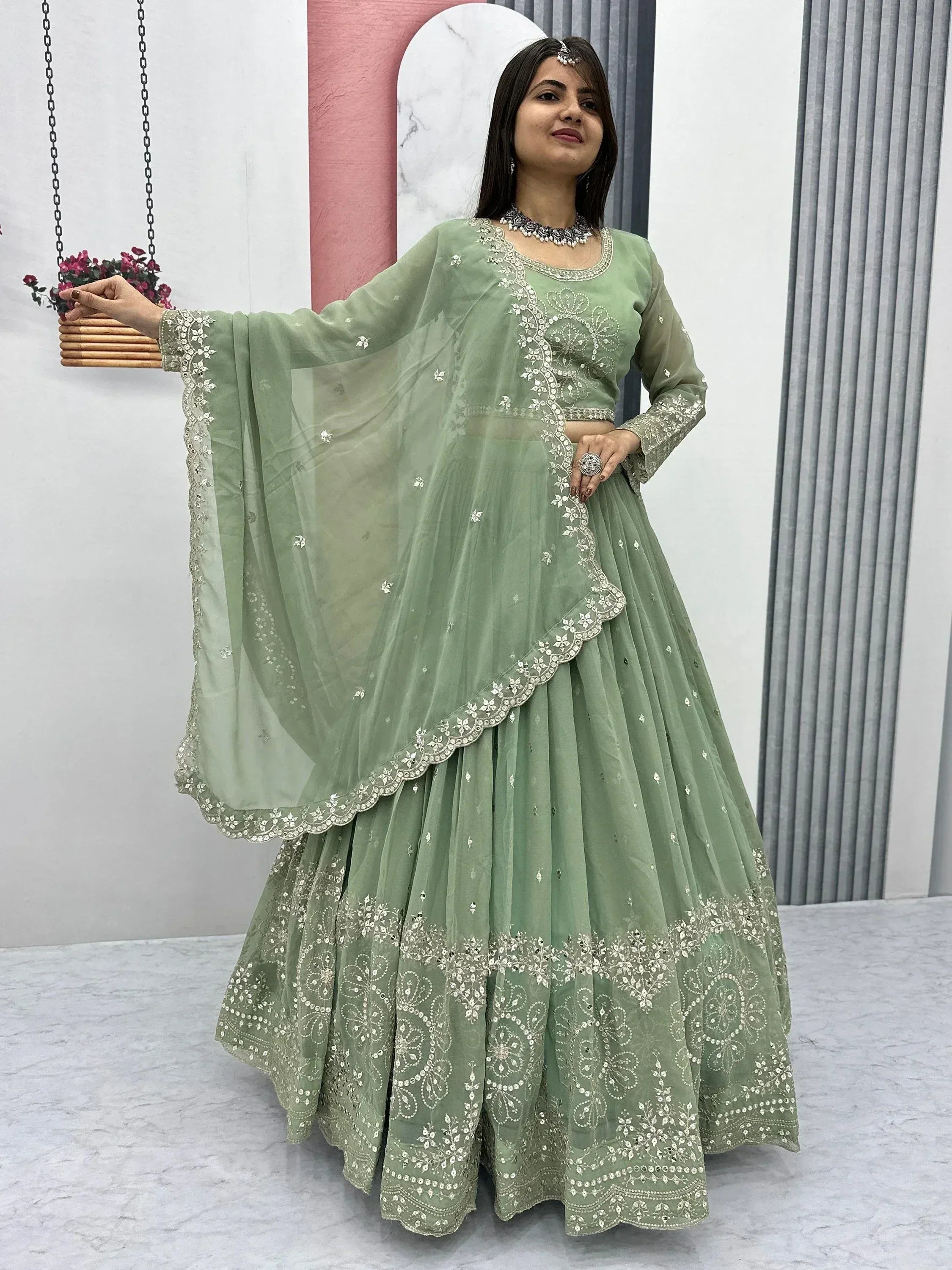 Mint green embroidered lehenga choli with sheer dupatta, perfect for Indian ethnic wear occasions.