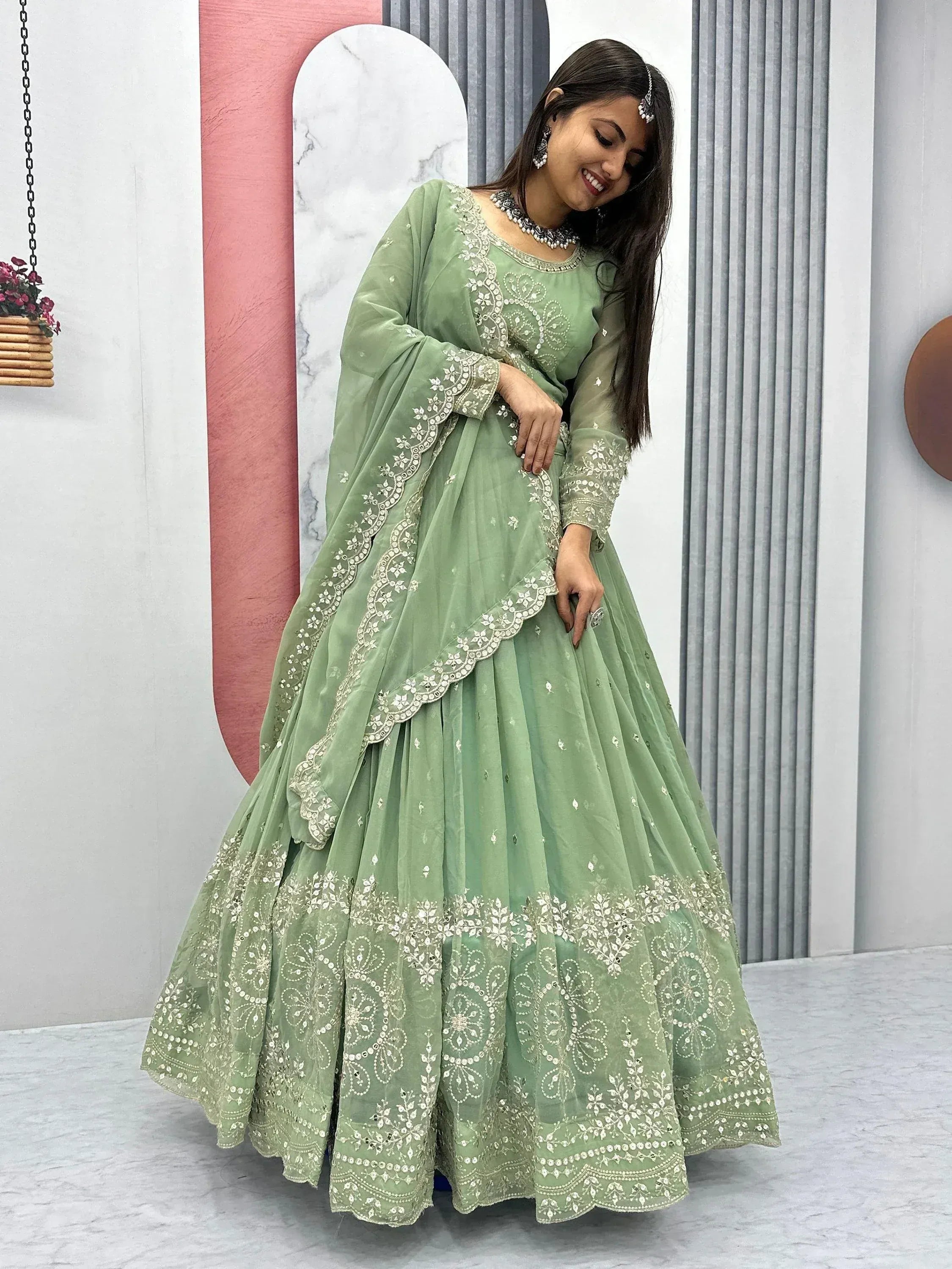 Mint green embroidered lehenga choli with floral detailing, perfect for Indian ethnic occasions.