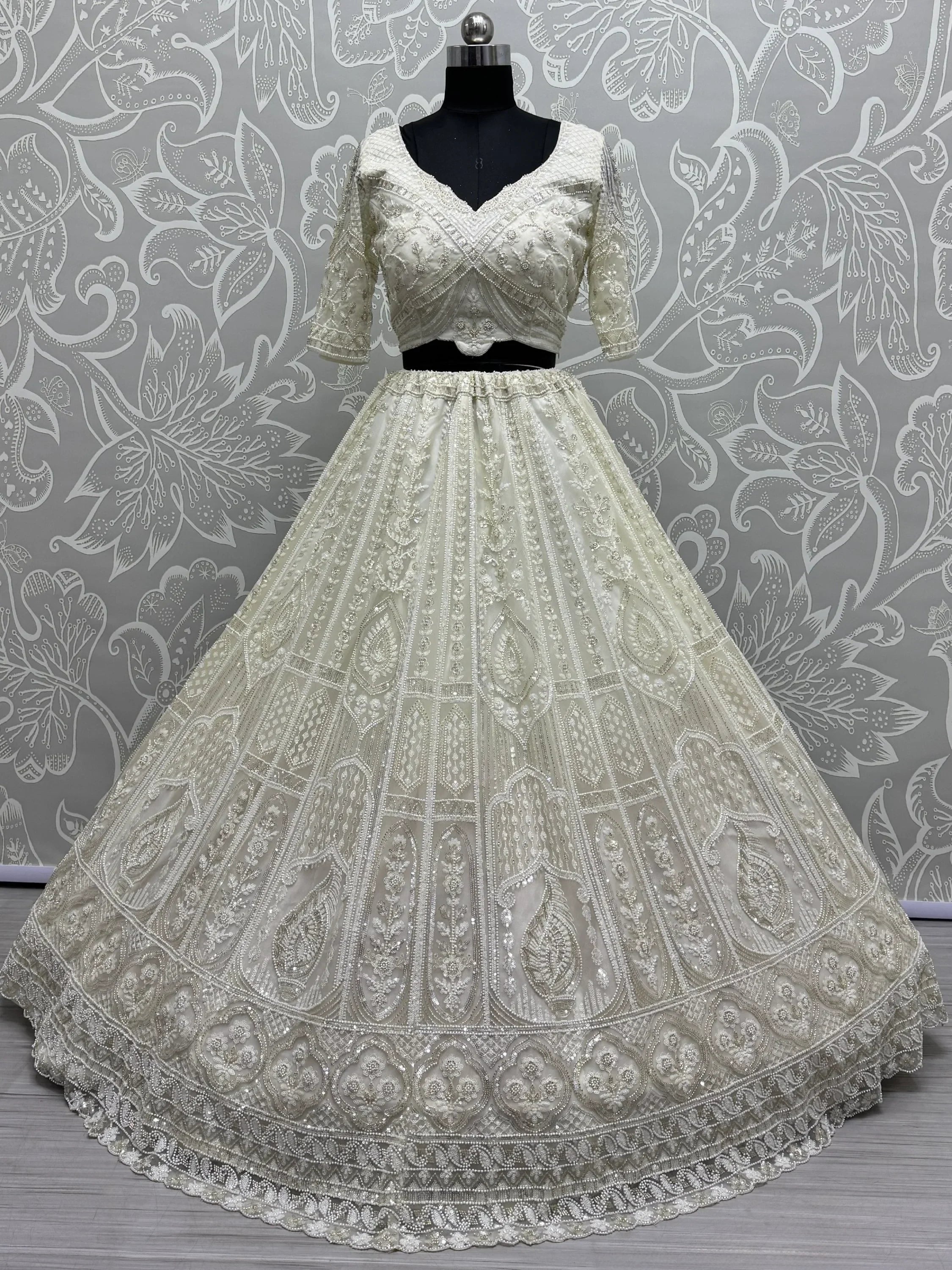 Ivory designer lehenga choli with heavy embroidery and beadwork, perfect for weddings and festivals