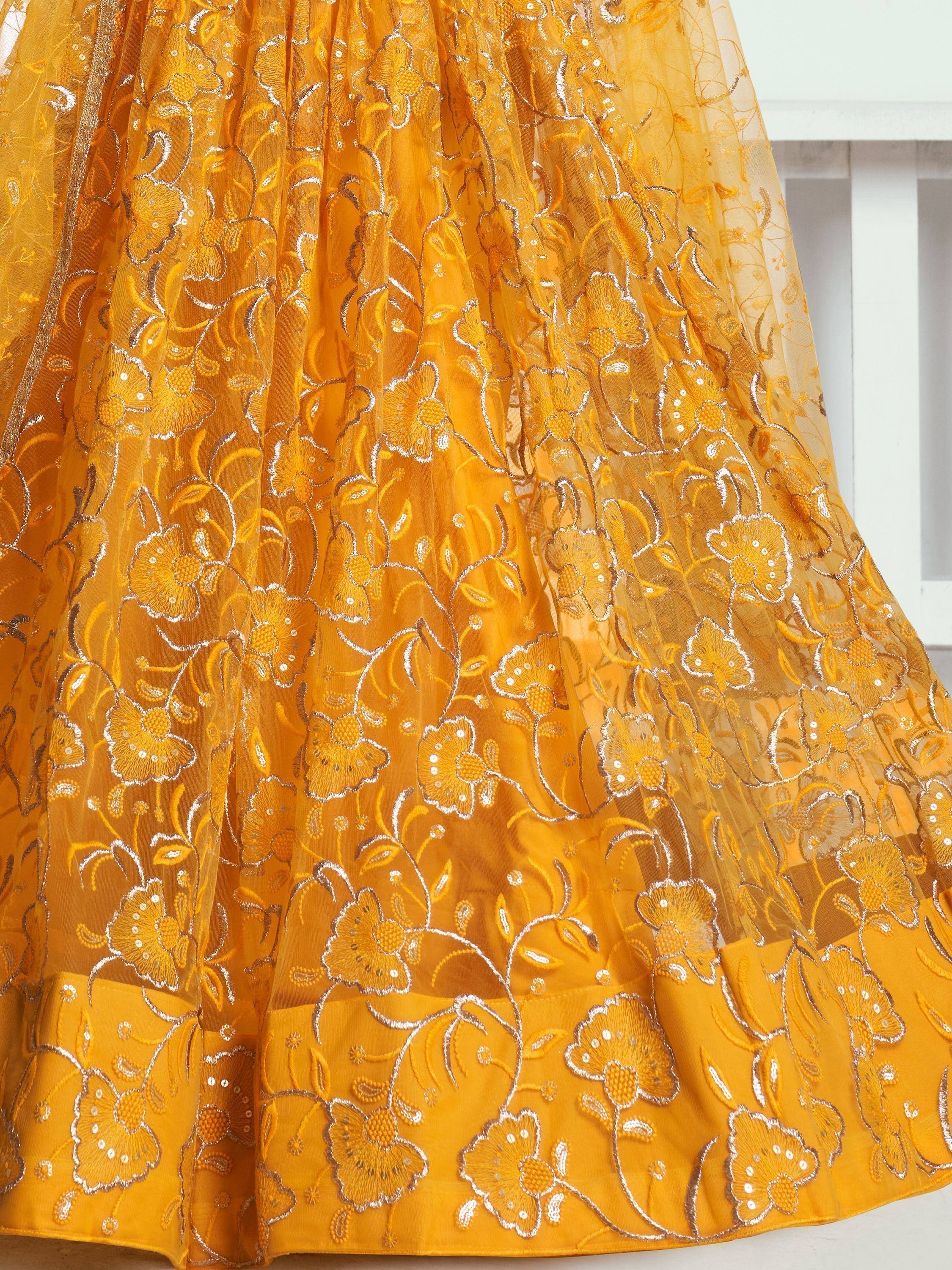 Mustard yellow ethnic gown with floral embroidery and sequins, perfect for Indian celebrations.