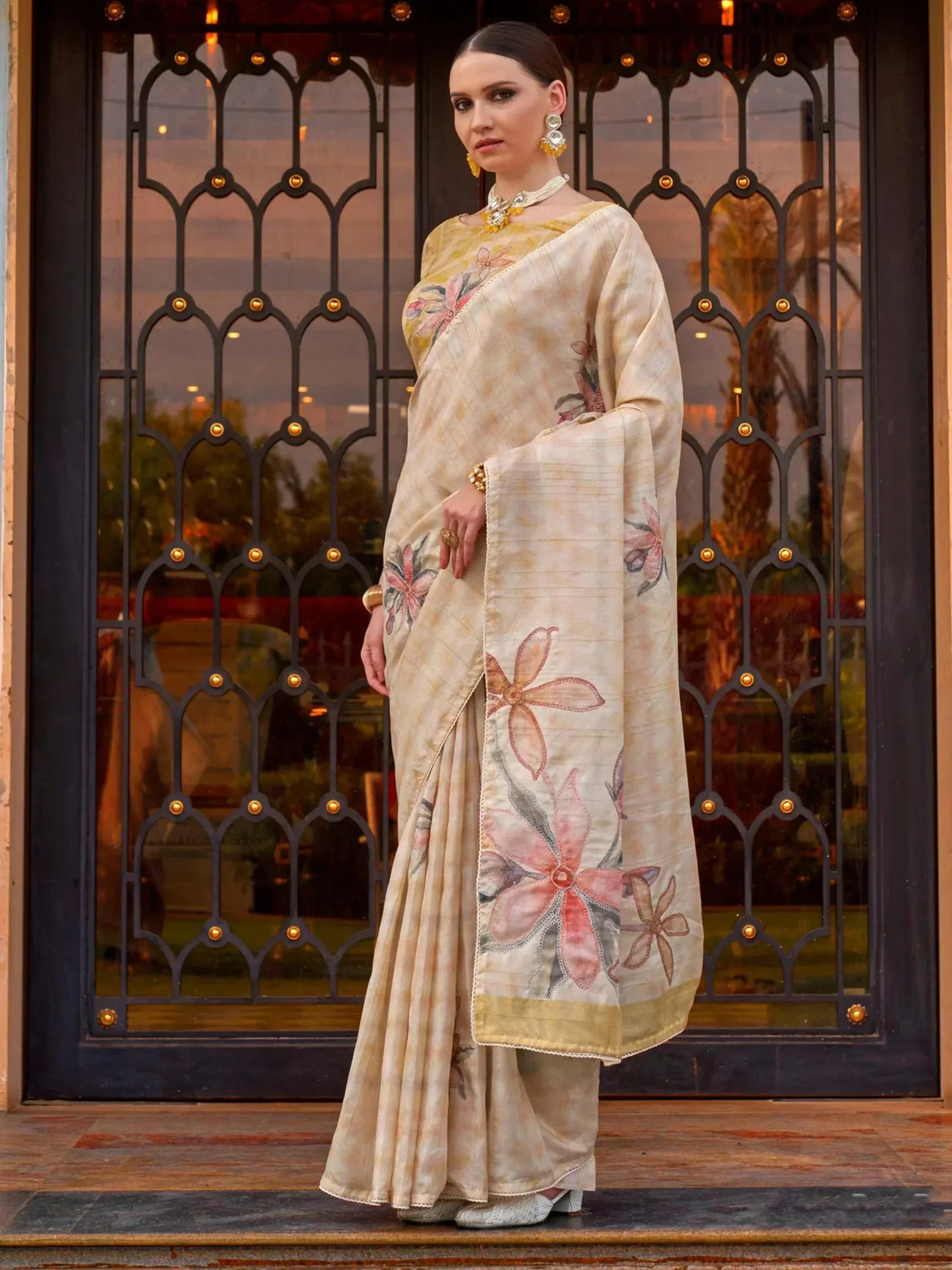 Elegant cream saree with floral embroidery, perfect for Indian ethnic wear and designer occasions.
