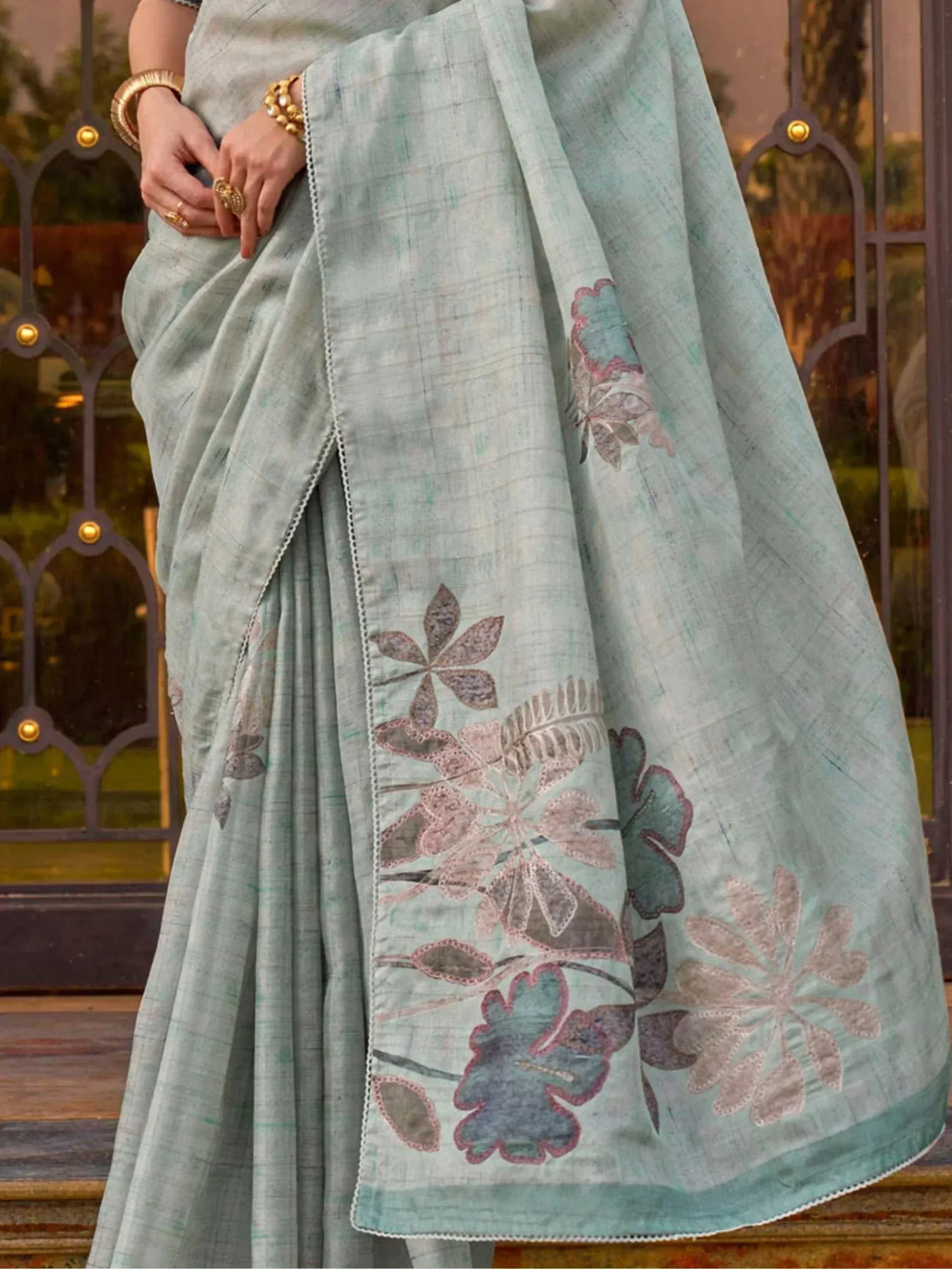 Mint green saree with floral embroidery, perfect for Indian ethnic wear occasions.