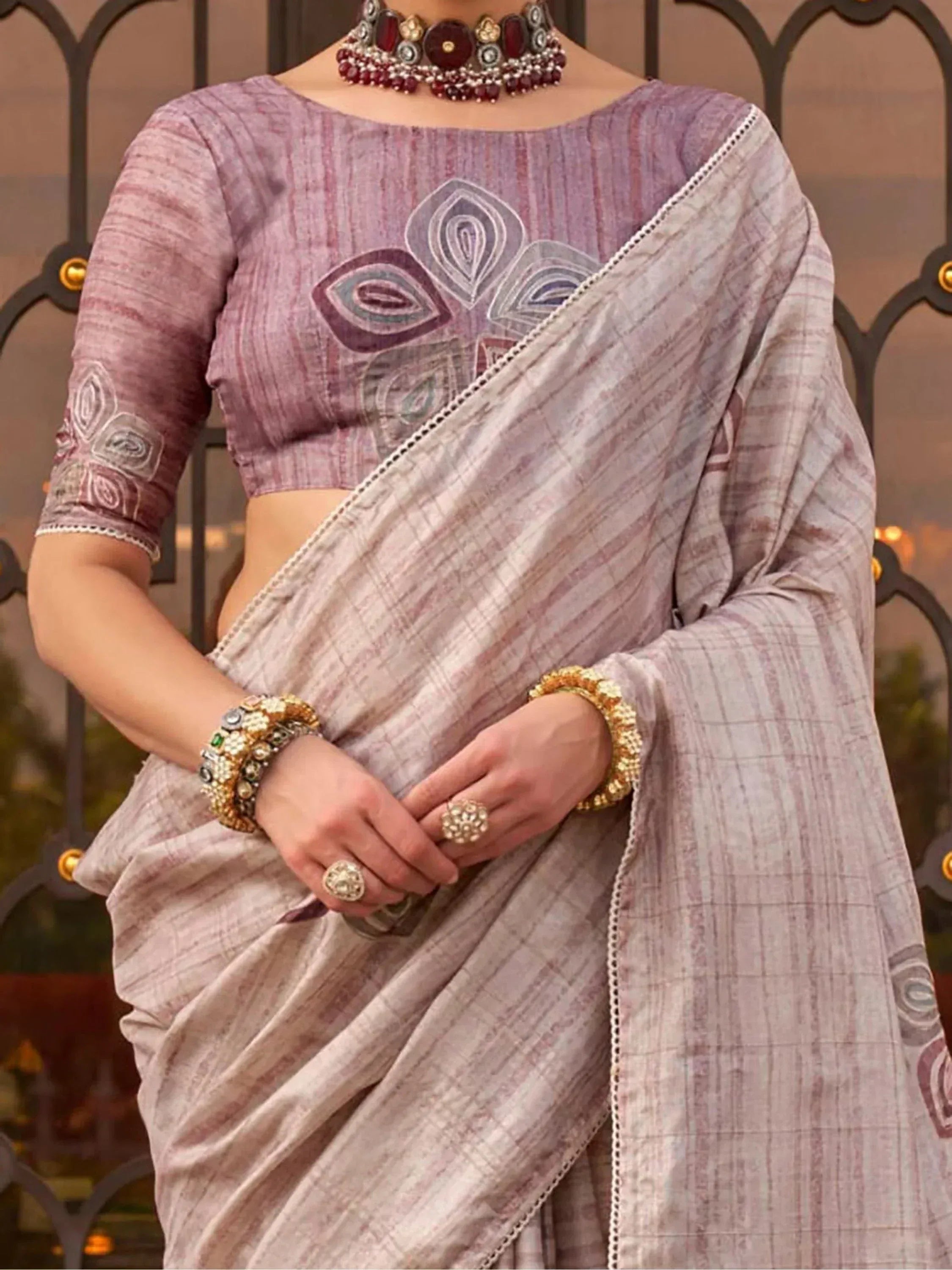 Purple embroidered saree with matching blouse, traditional Indian ethnic wear, adorned with jewelry
