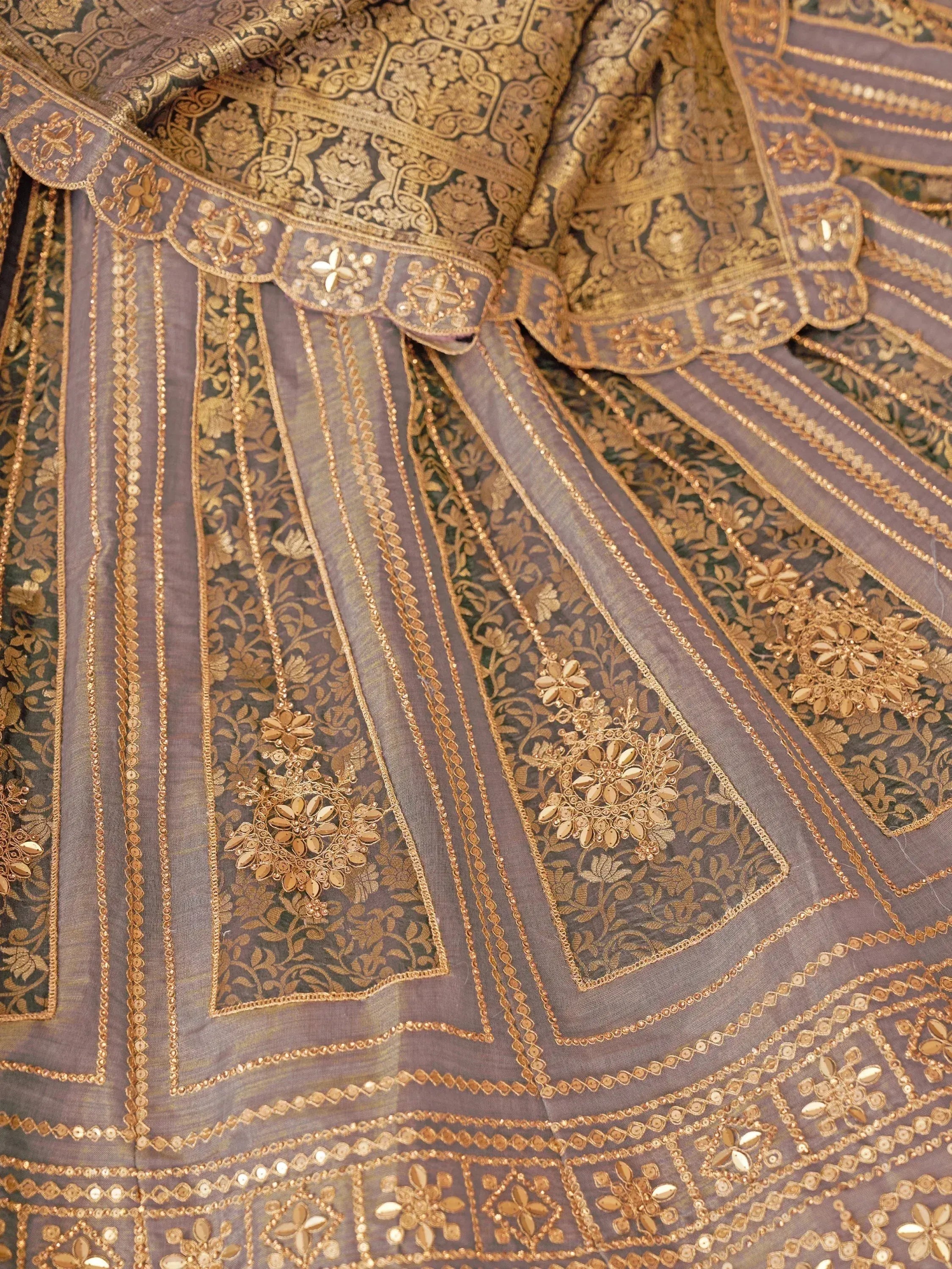 Luxury grey lehenga with intricate gold embroidery and floral motifs, perfect for Indian ethnic wear.