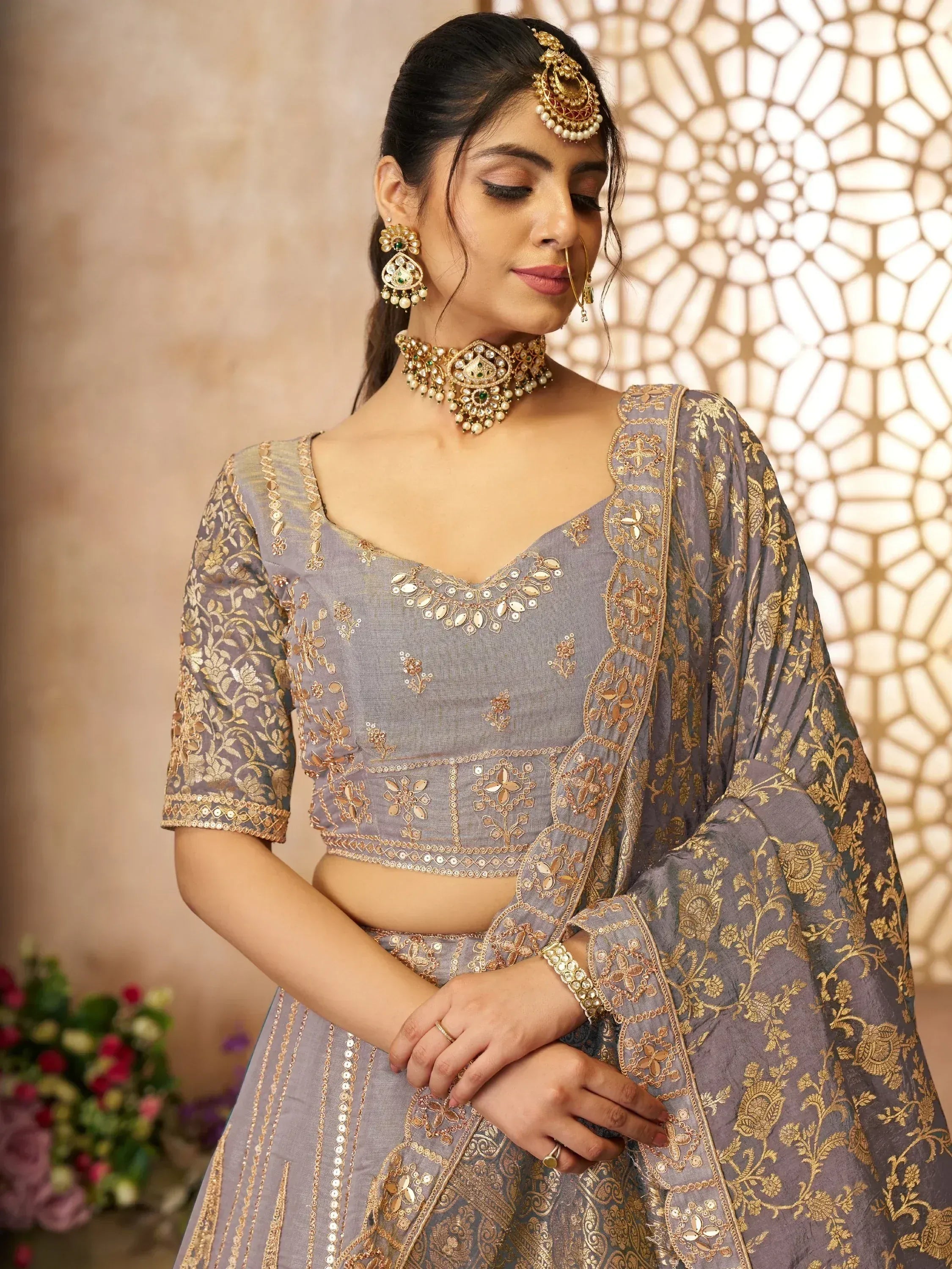 Grey and gold embroidered lehenga choli with matching jewelry for Indian ethnic wear