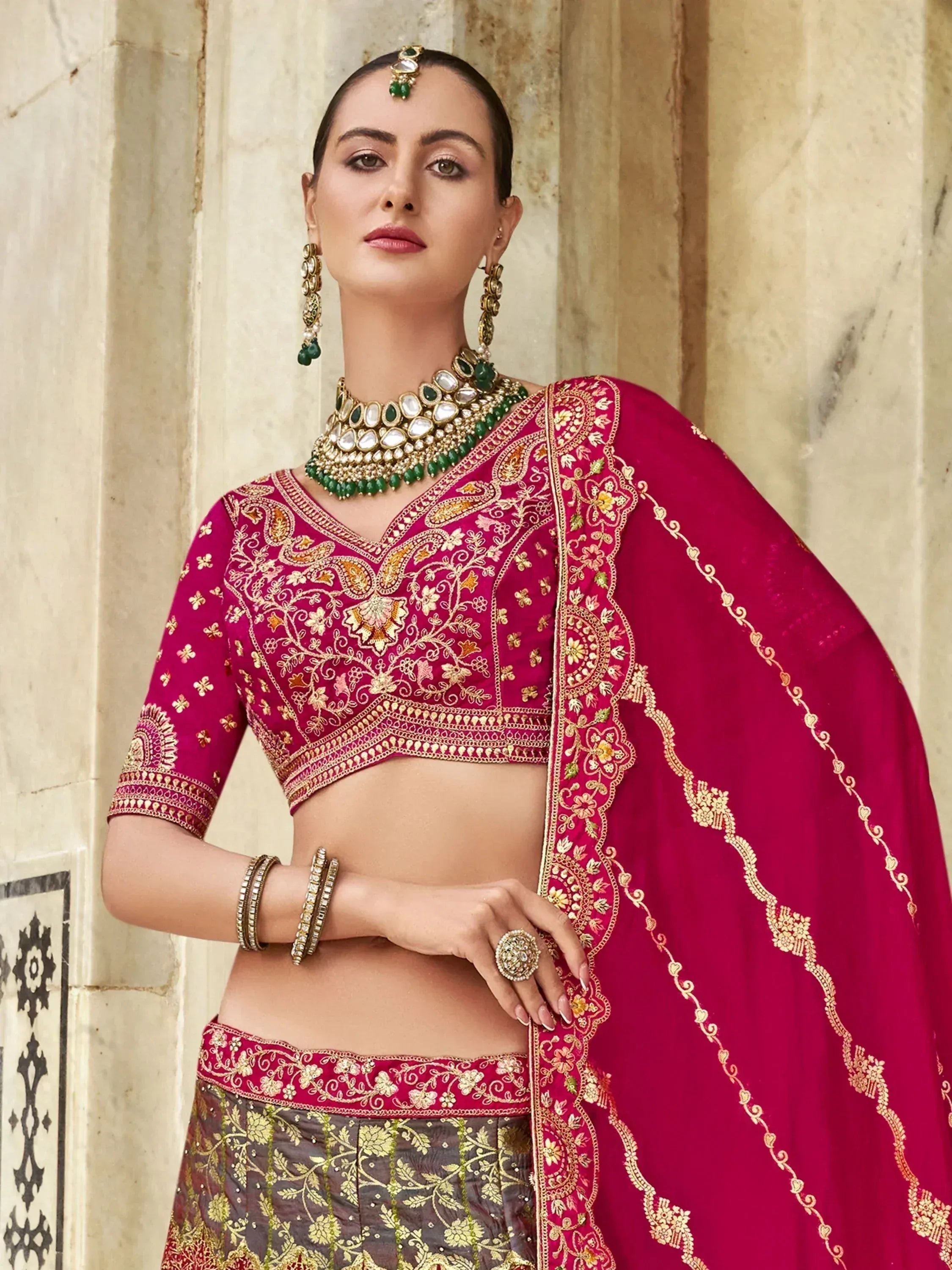 Elegant maroon lehenga choli with gold embroidery, perfect for Indian weddings and festive occasions.