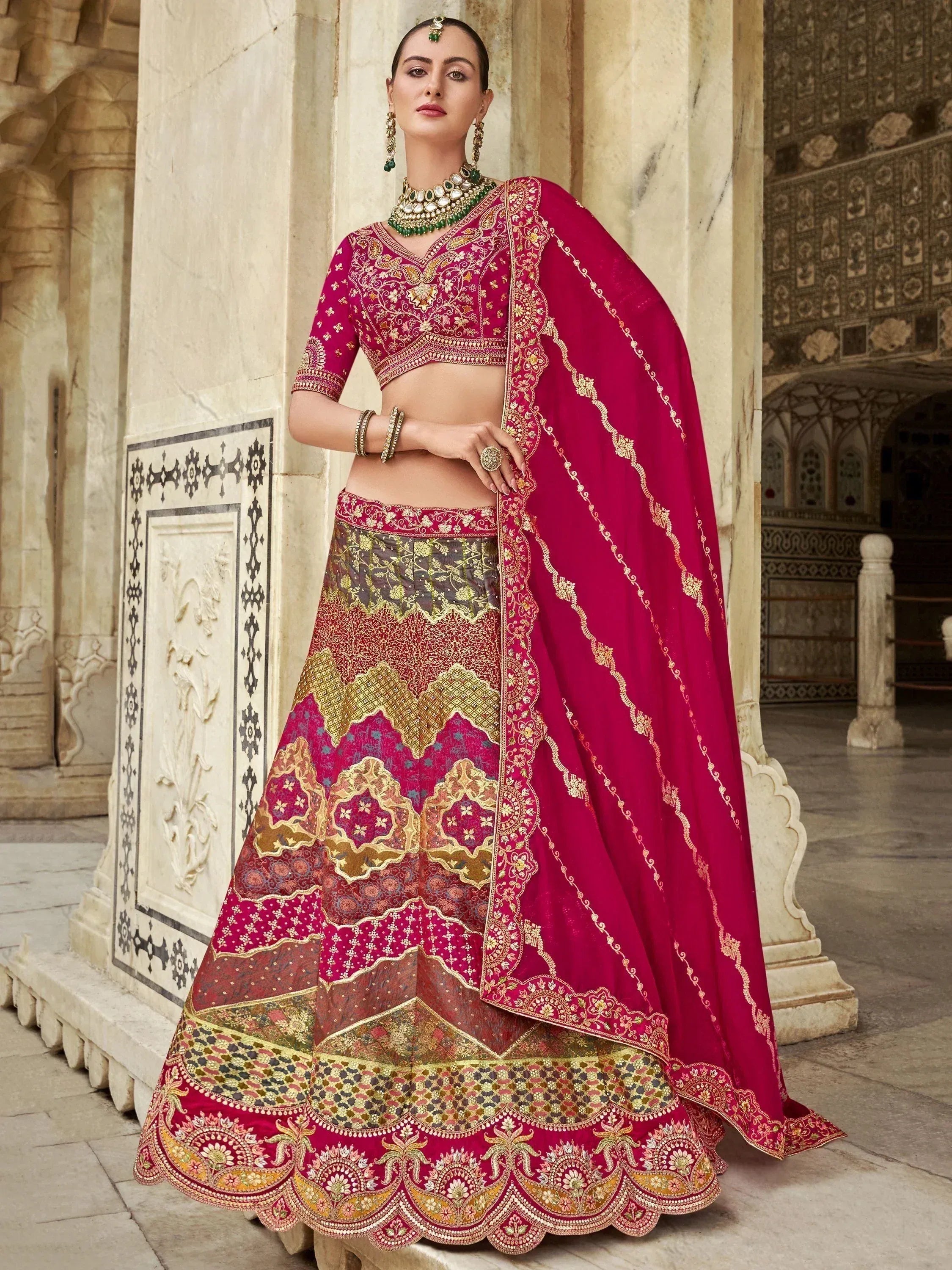 Elegant maroon lehenga choli with intricate gold embroidery, perfect for Indian weddings and festive occasions.