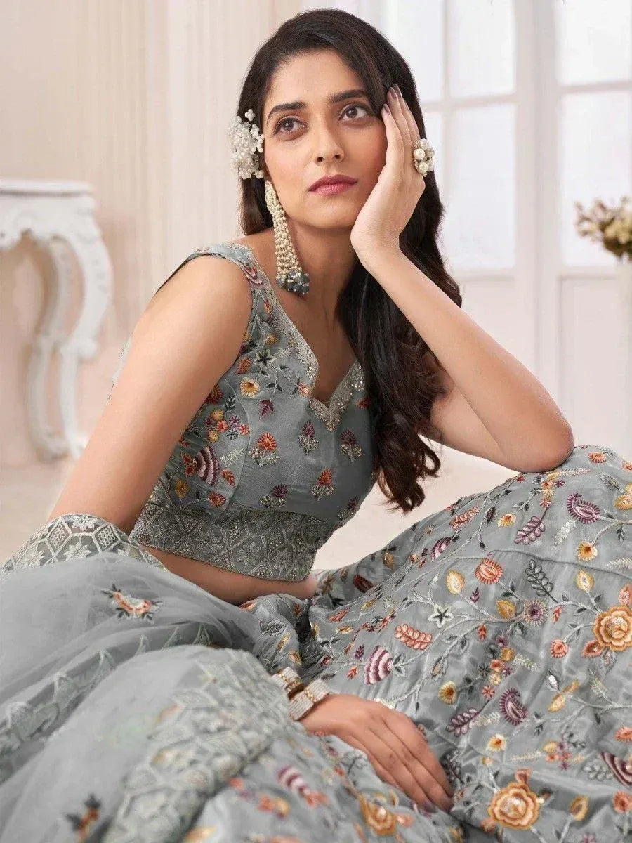 Grey floral embroidered lehenga choli with designer blouse and matching skirt, perfect for Indian ethnic occasions.