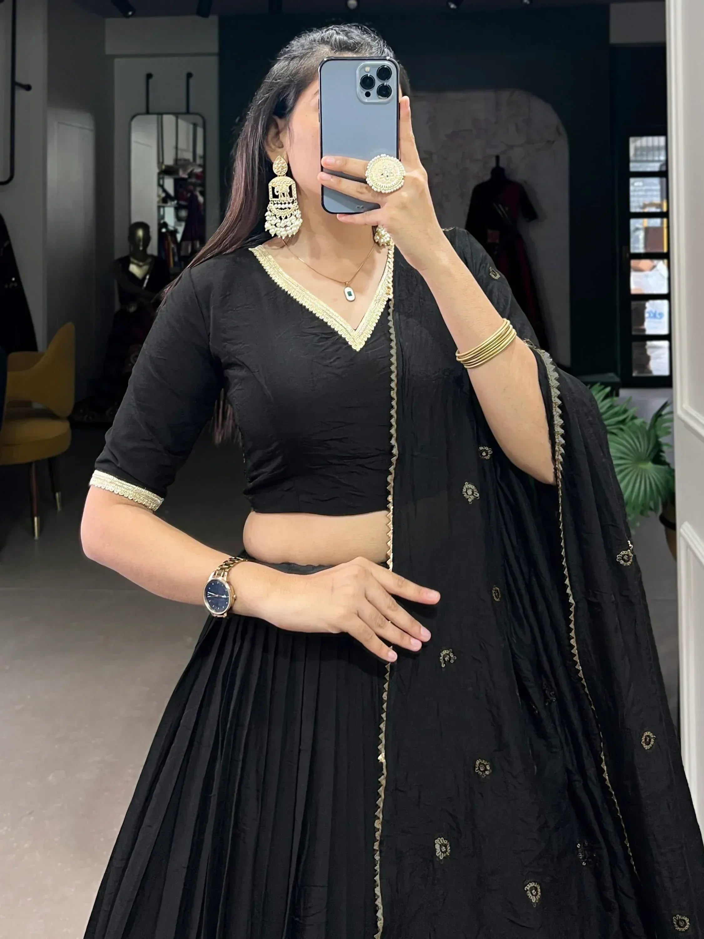 Black ethnic lehenga choli with gold embroidery, perfect for Indian weddings or festive occasions.