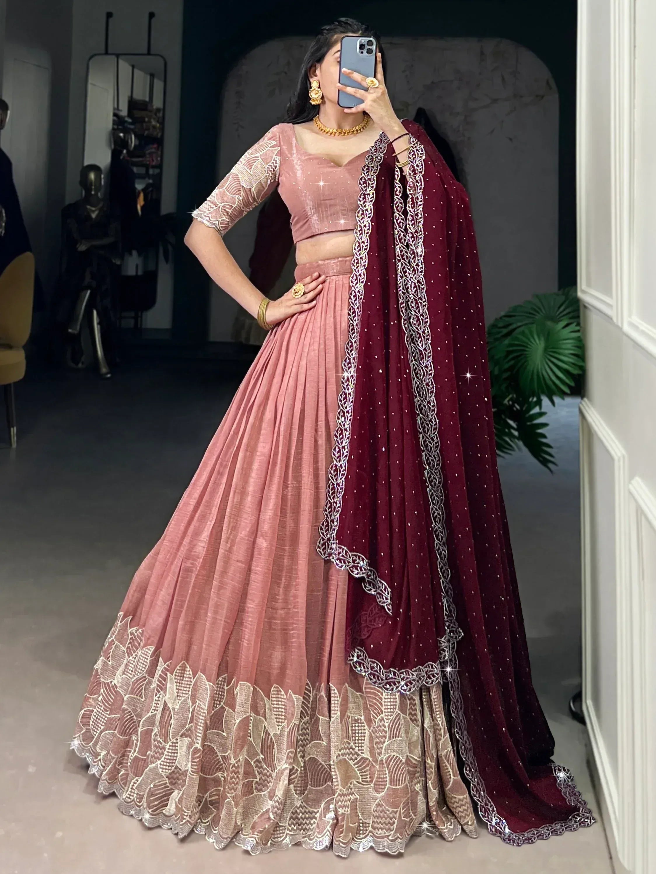 Pink velvet lehenga choli with maroon dupatta, intricate gold embroidery, perfect for Indian weddings or festive occasions.