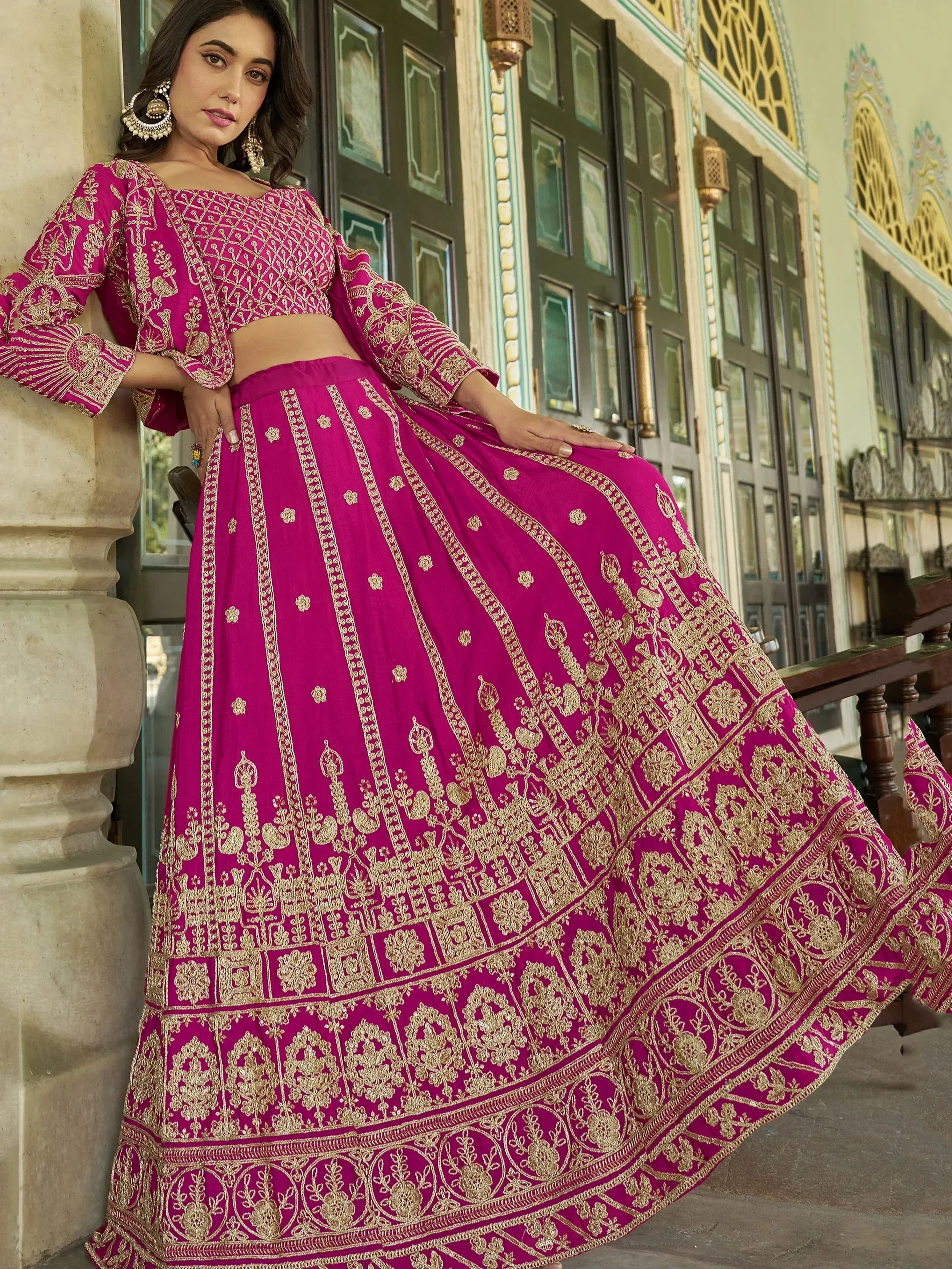 Fuchsia pink embroidered lehenga choli with gold detailing, perfect for Indian ethnic wear and festive occasions.