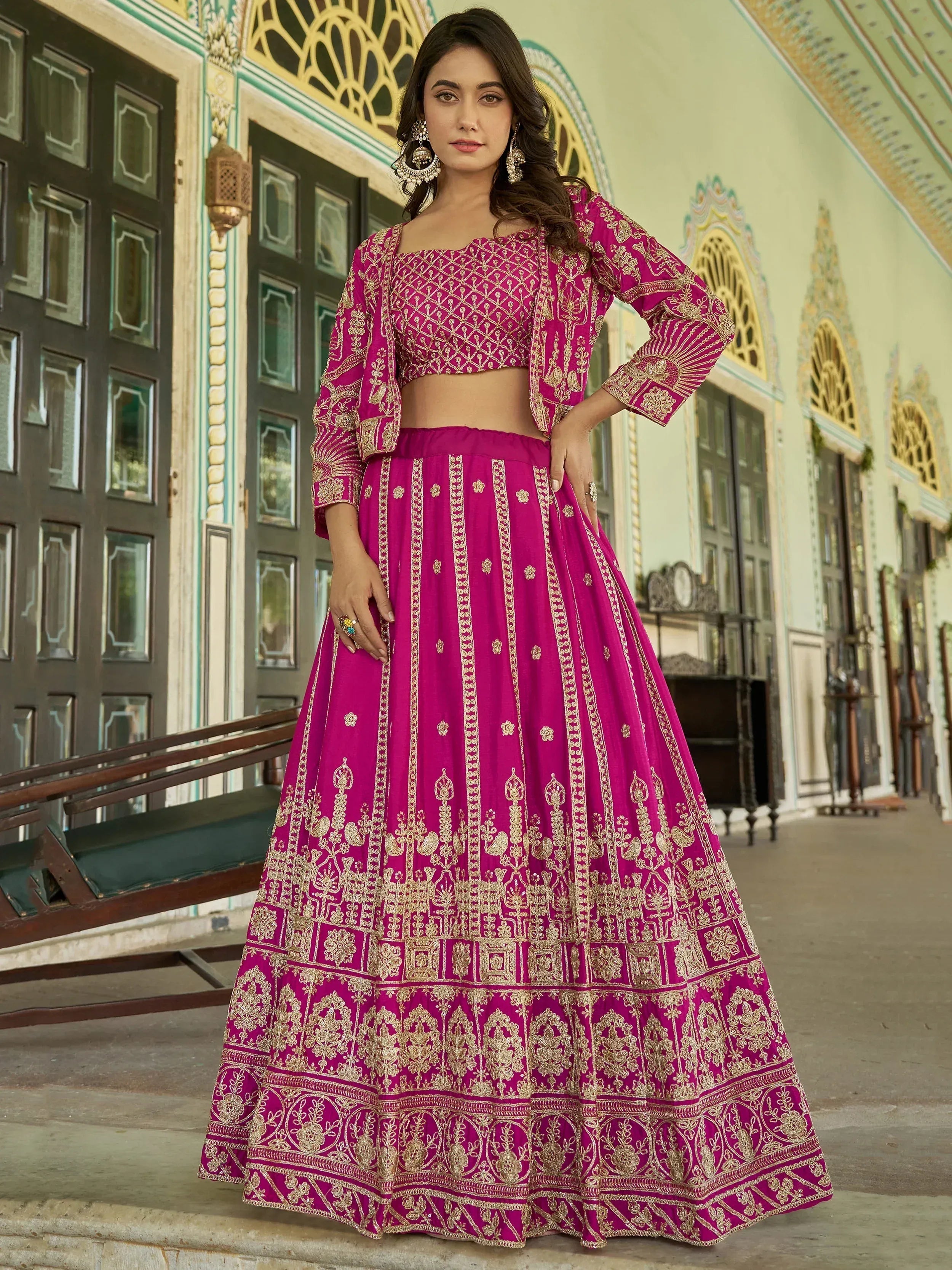 Fuchsia pink embroidered lehenga choli with gold detailing, perfect for Indian ethnic occasions