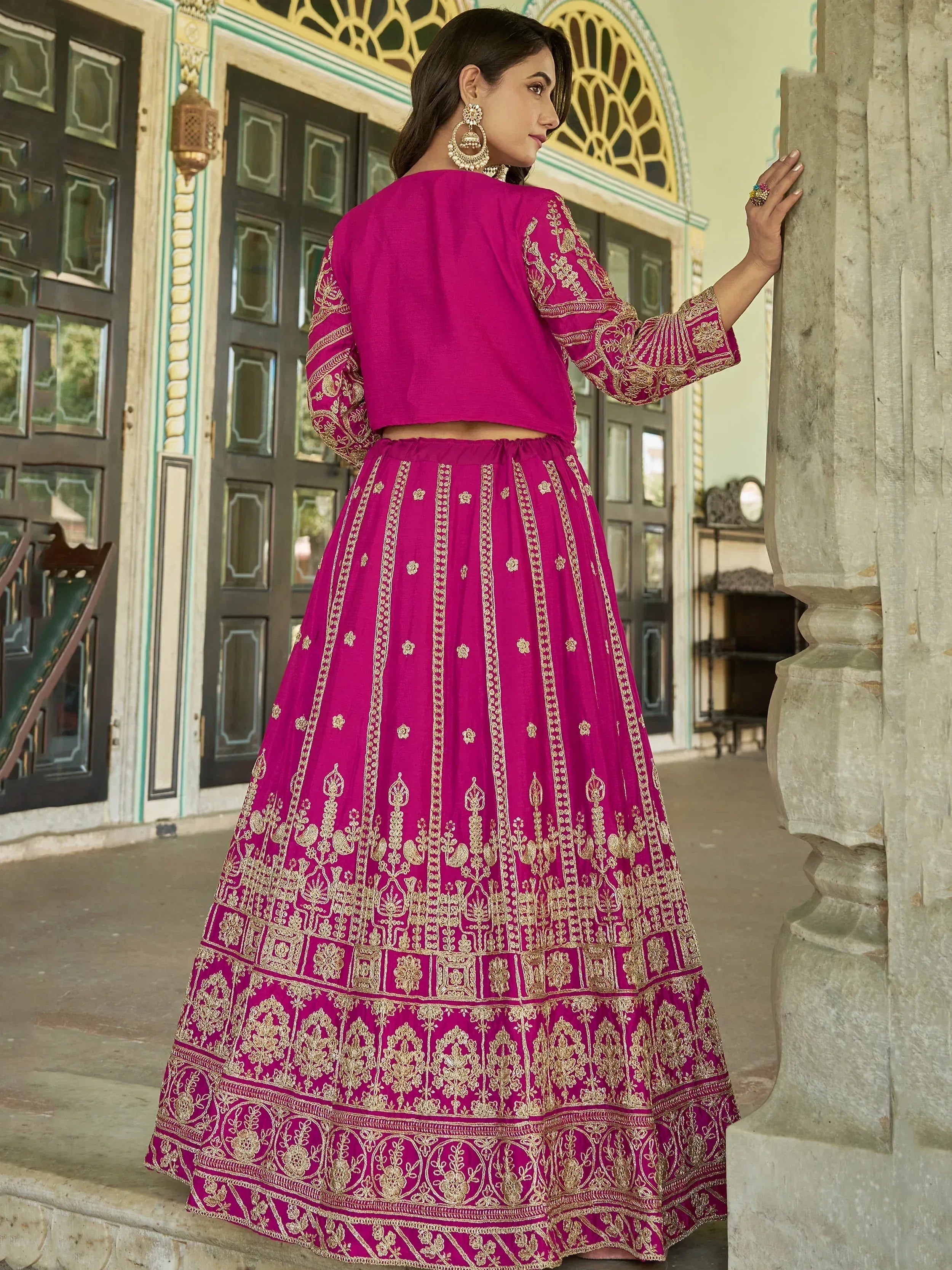 Fuchsia pink embroidered lehenga choli with gold detailing, perfect for Indian ethnic wear occasions