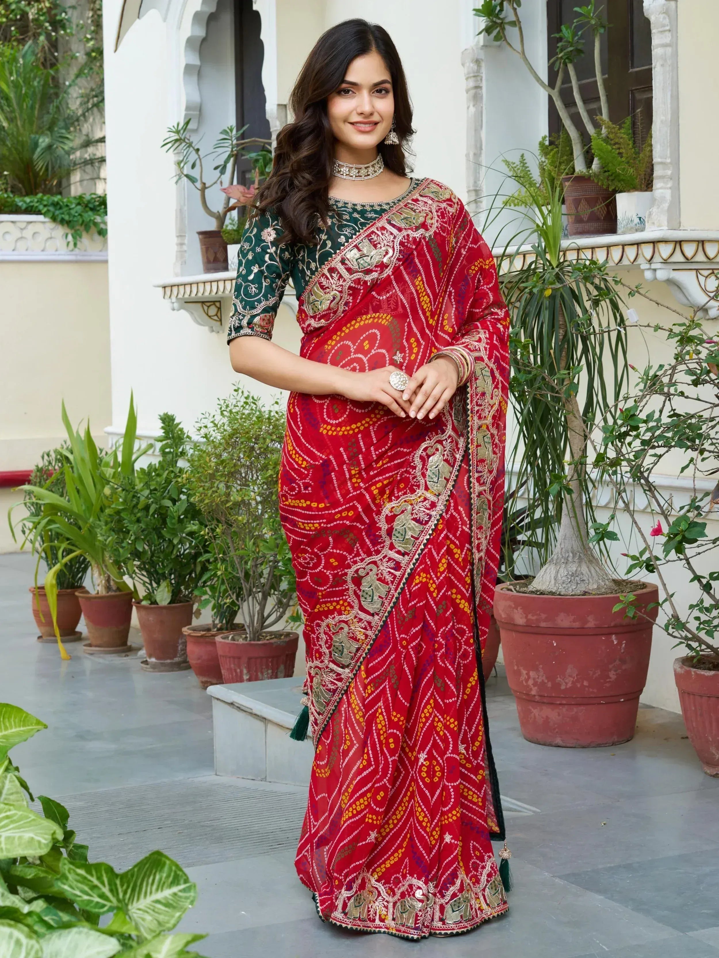 Red embroidered saree with elephant motifs, paired with green blouse, perfect for Indian ethnic occasions