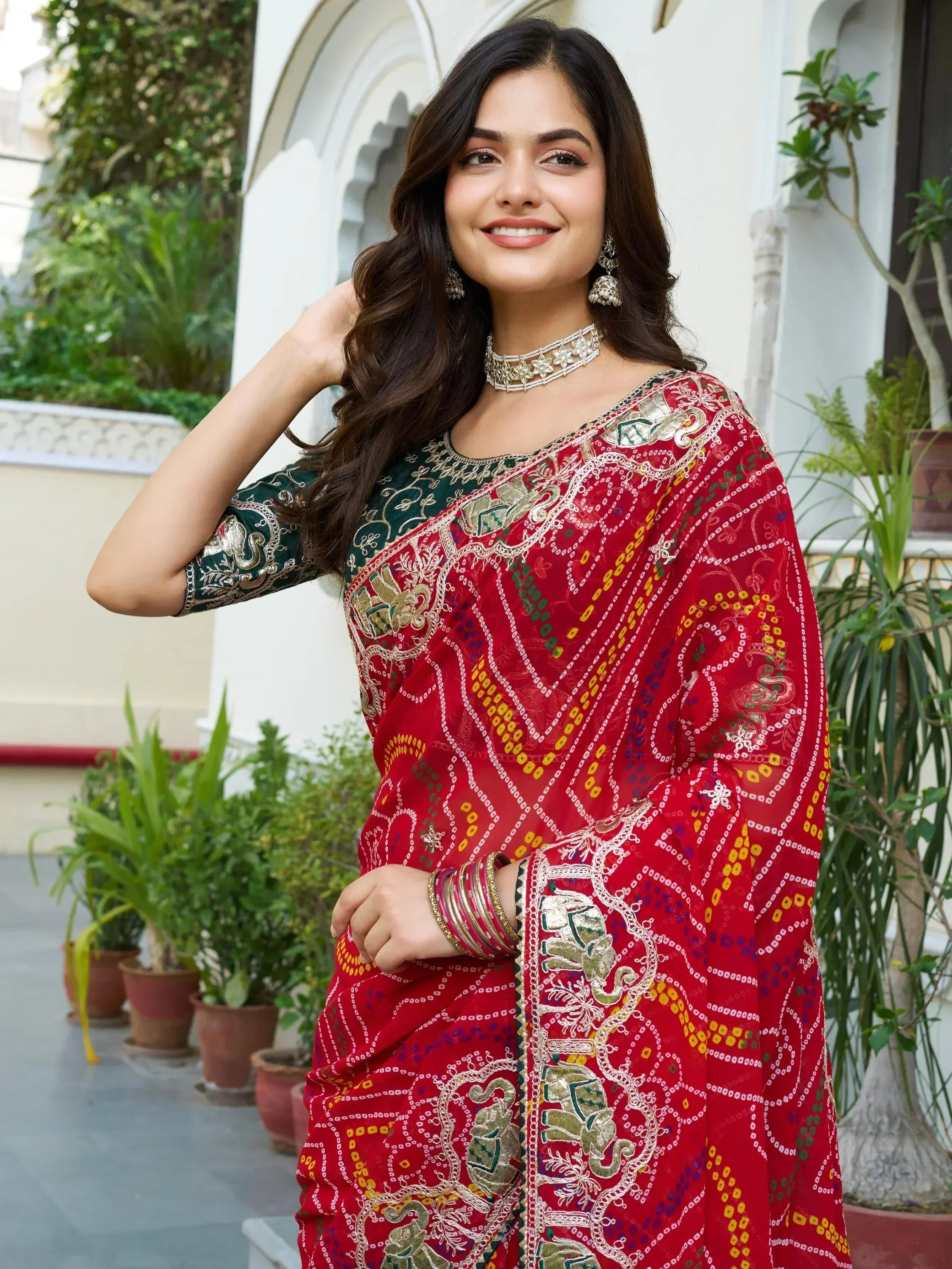 Red and green embroidered ethnic saree with elephant motifs, perfect for Indian celebrations