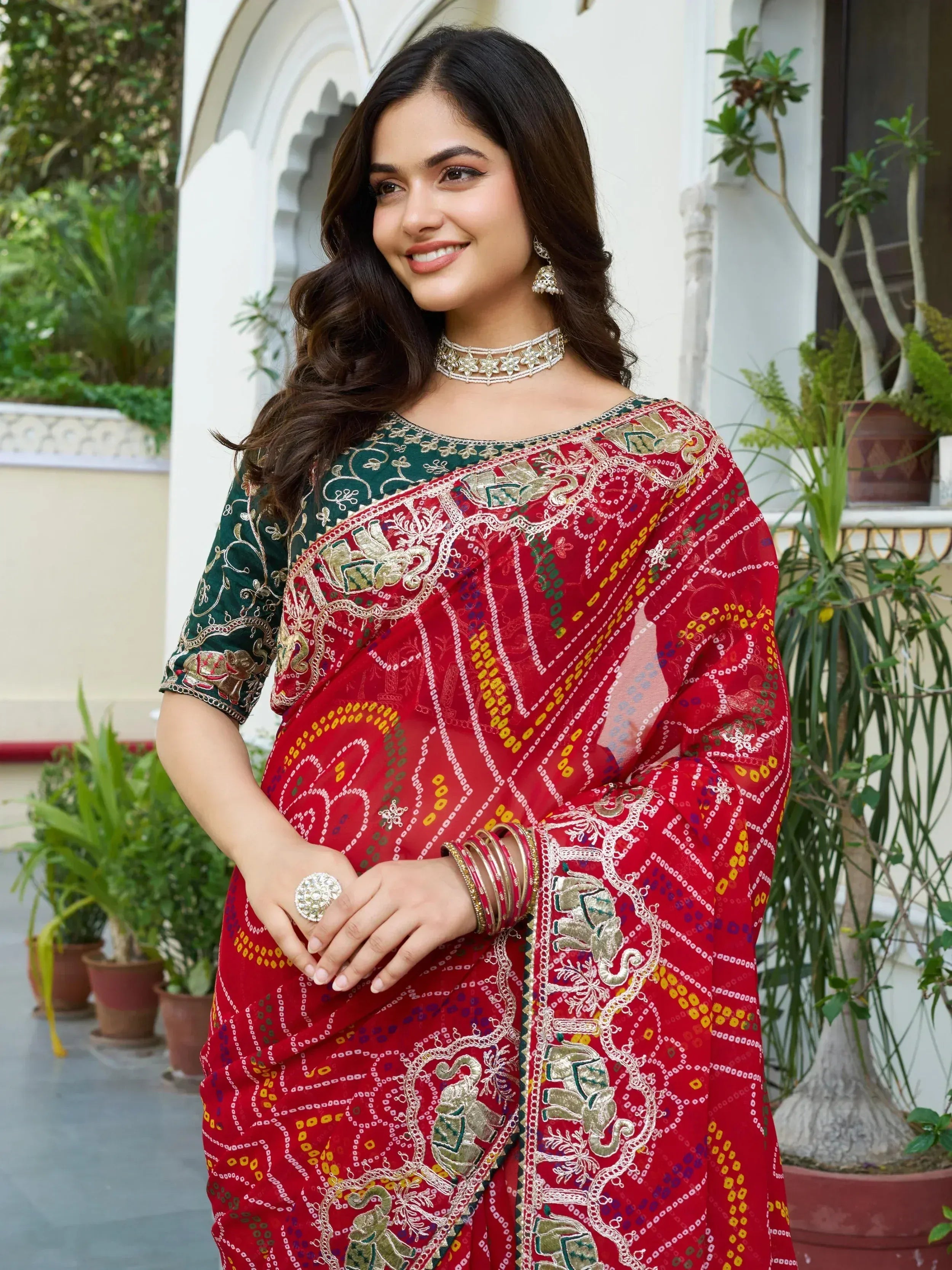 Red and green embroidered saree with elephant motifs, traditional Indian ethnic wear