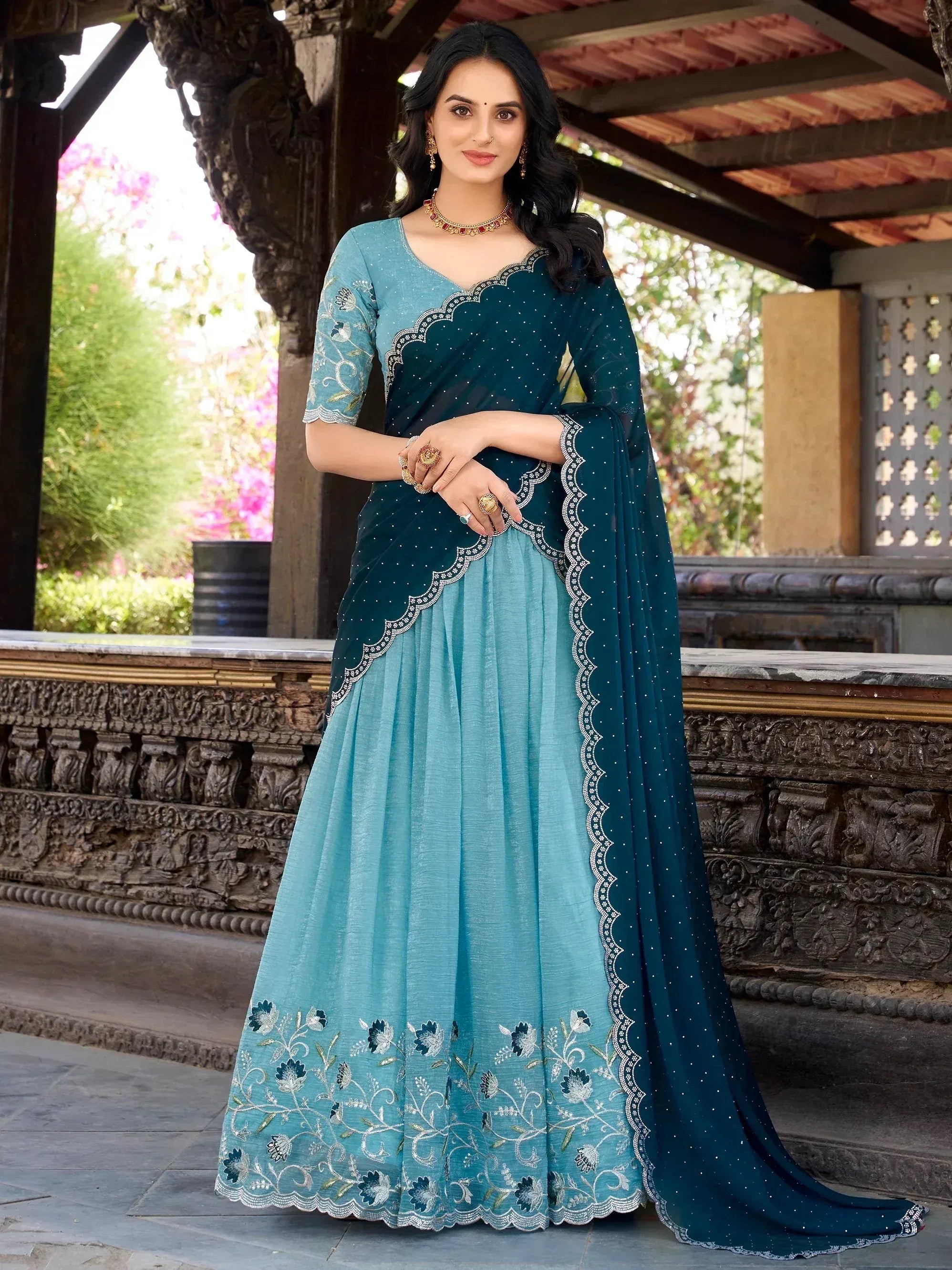 Teal and blue embroidered ethnic gown with floral detailing, perfect for Indian occasions and festive wear.