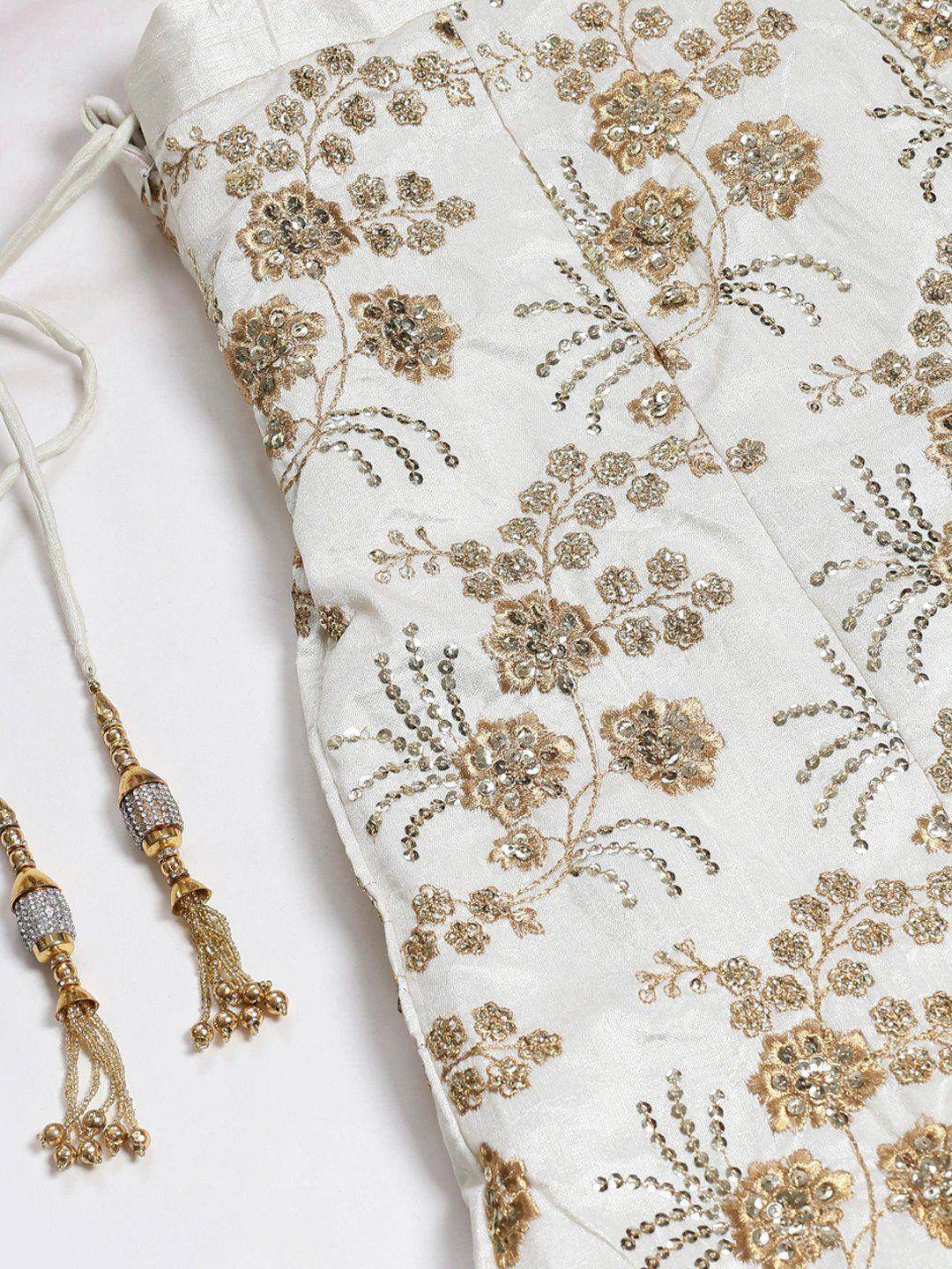 White ethnic gown with gold floral embroidery and beaded tassels, perfect for Indian weddings and festive occasions.