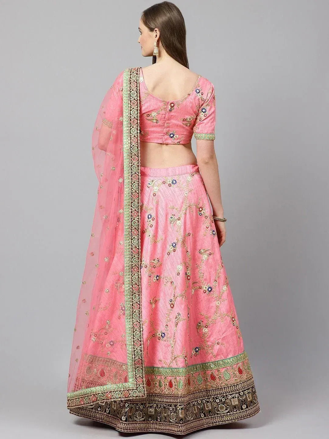 Pink embroidered lehenga choli with floral motifs and green border, ideal for Indian ethnic wear occasions