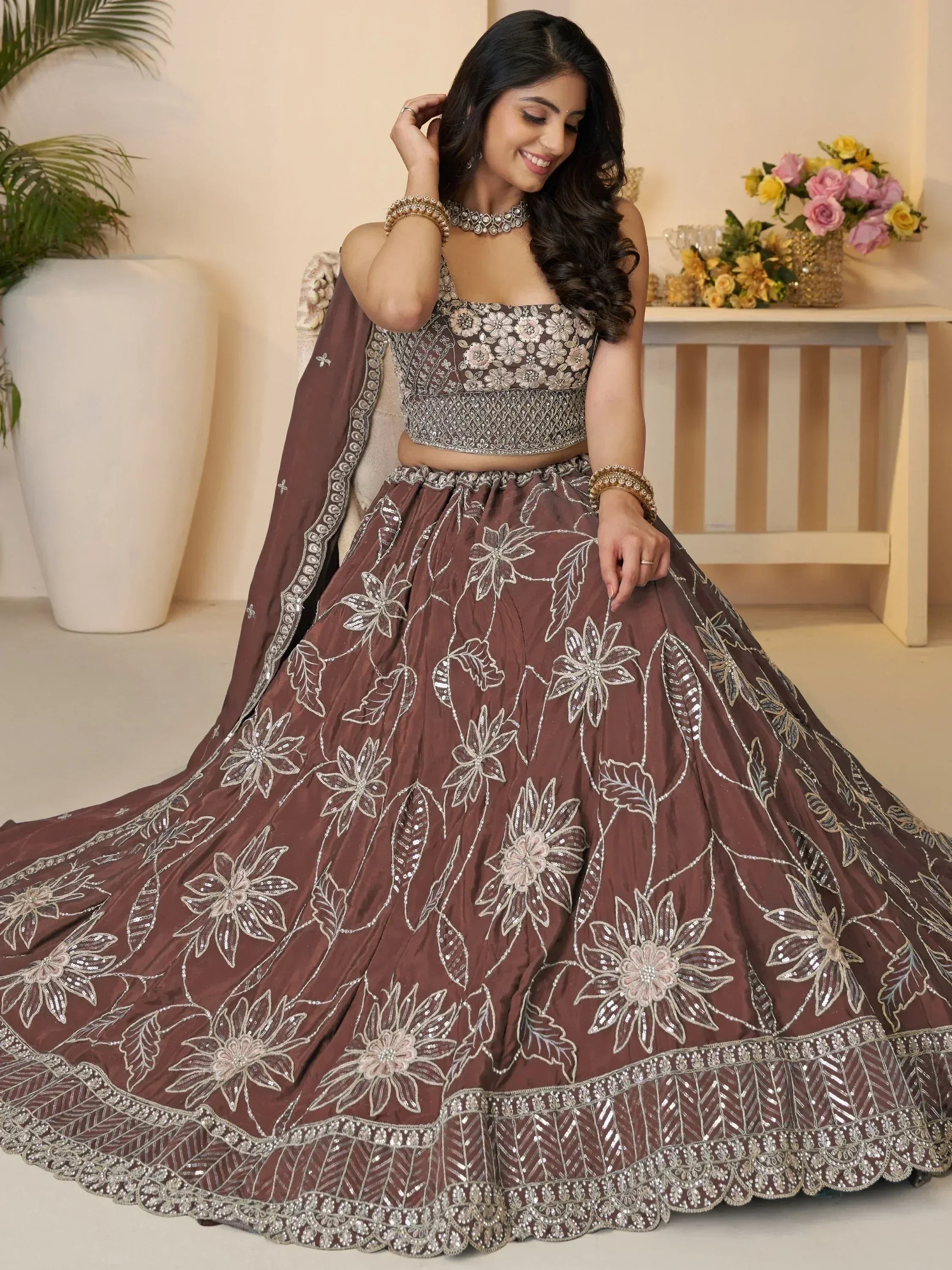 Elegant brown lehenga choli with floral embroidery and sequin work, perfect for Indian weddings and festive occasions.