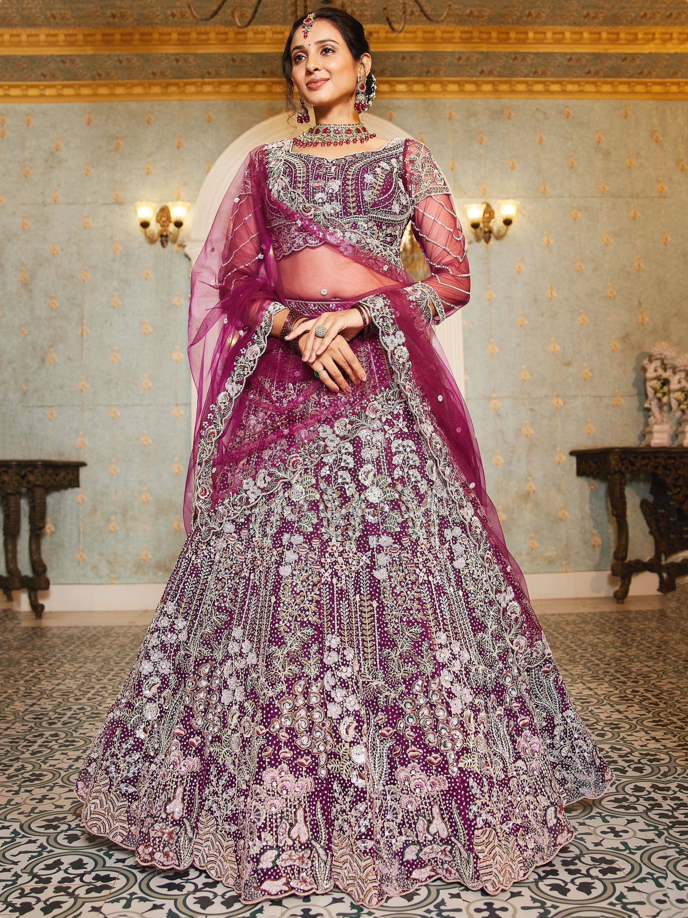 Elegant purple designer lehenga choli with intricate floral embroidery and sheer dupatta, perfect for weddings.