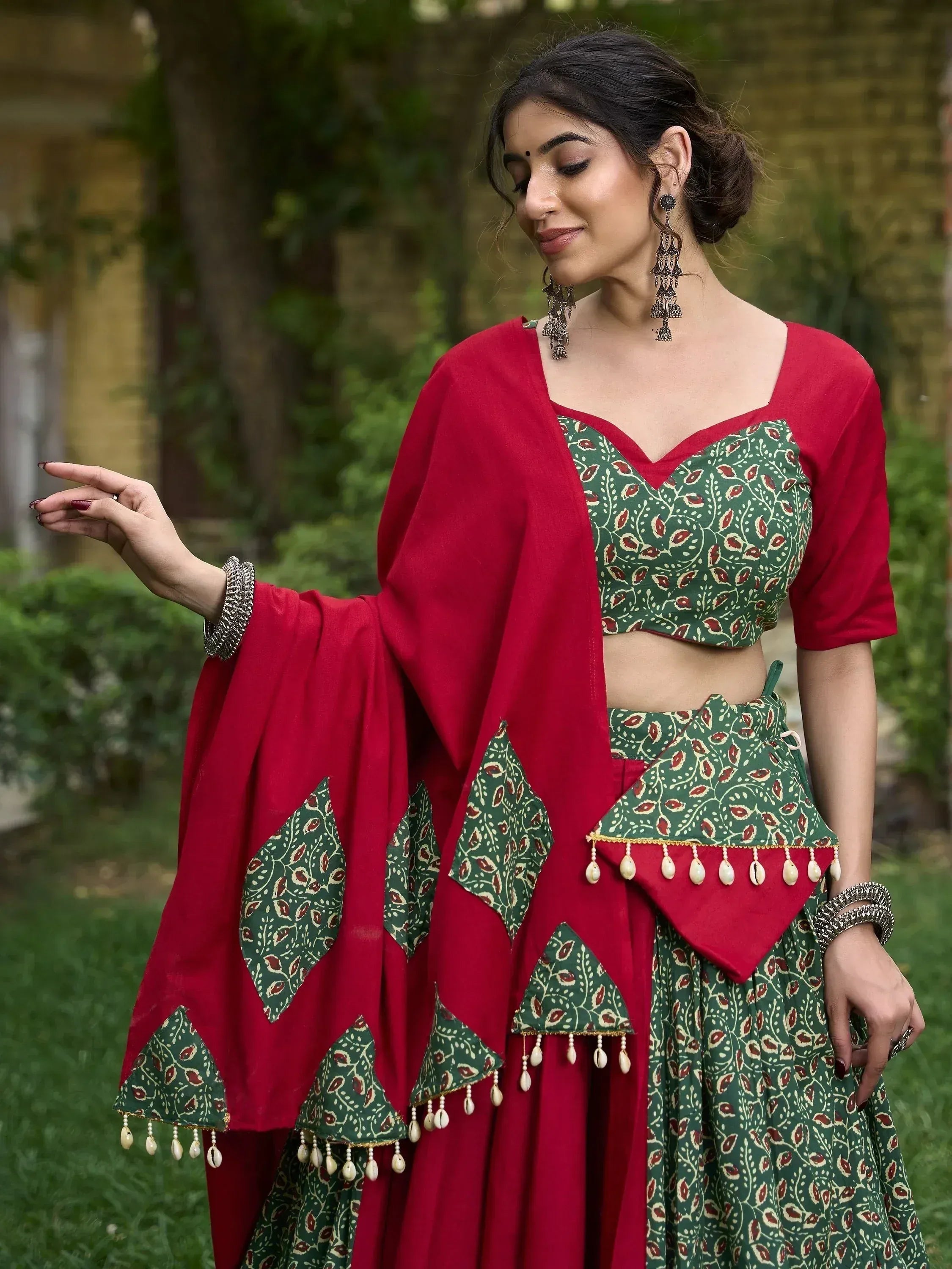 Green and red printed lehenga choli with shell tassels, perfect for ethnic occasions