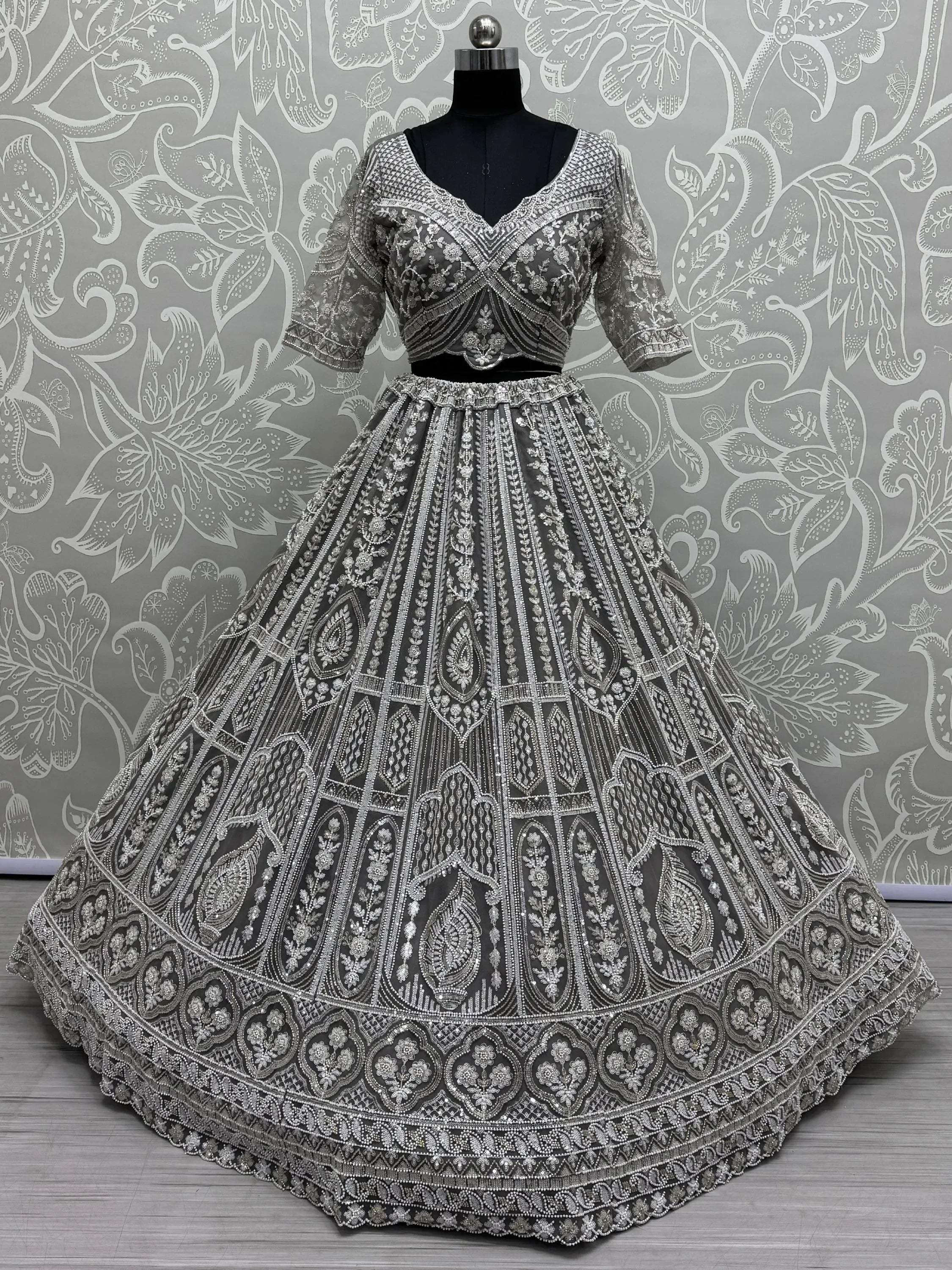 Grey designer lehenga choli with heavy silver embroidery and beadwork, perfect for weddings and festive occasions.