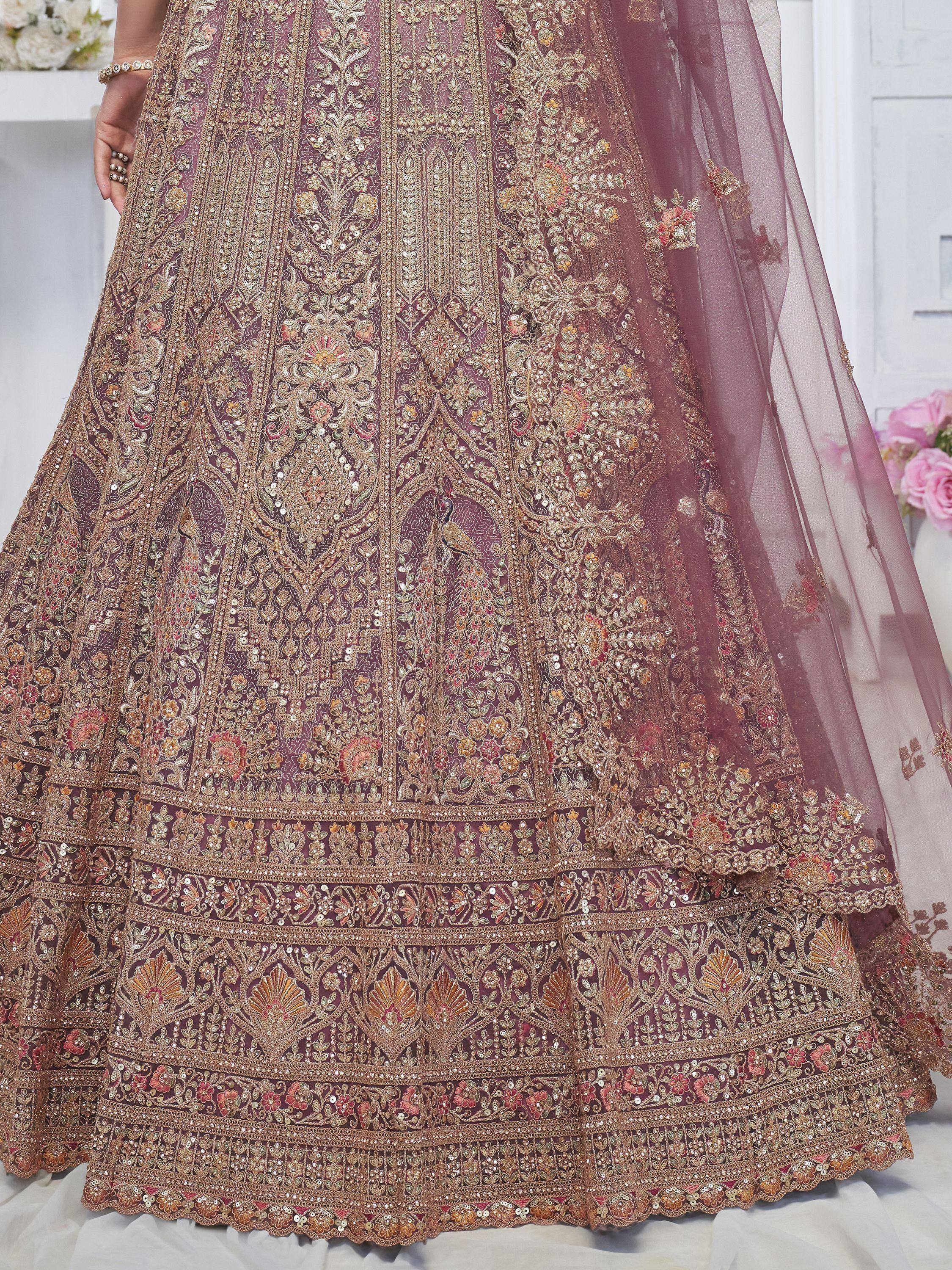 Luxury maroon lehenga choli with heavy gold embroidery and floral motifs, perfect for weddings