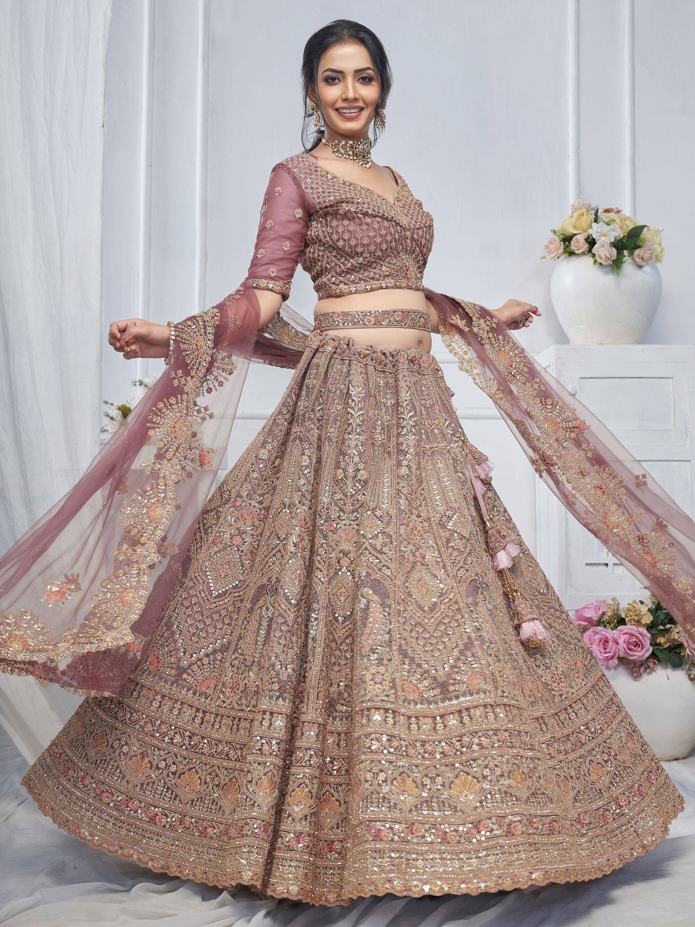 Elegant mauve lehenga choli with heavy gold embroidery, perfect for Indian weddings and festive occasions.