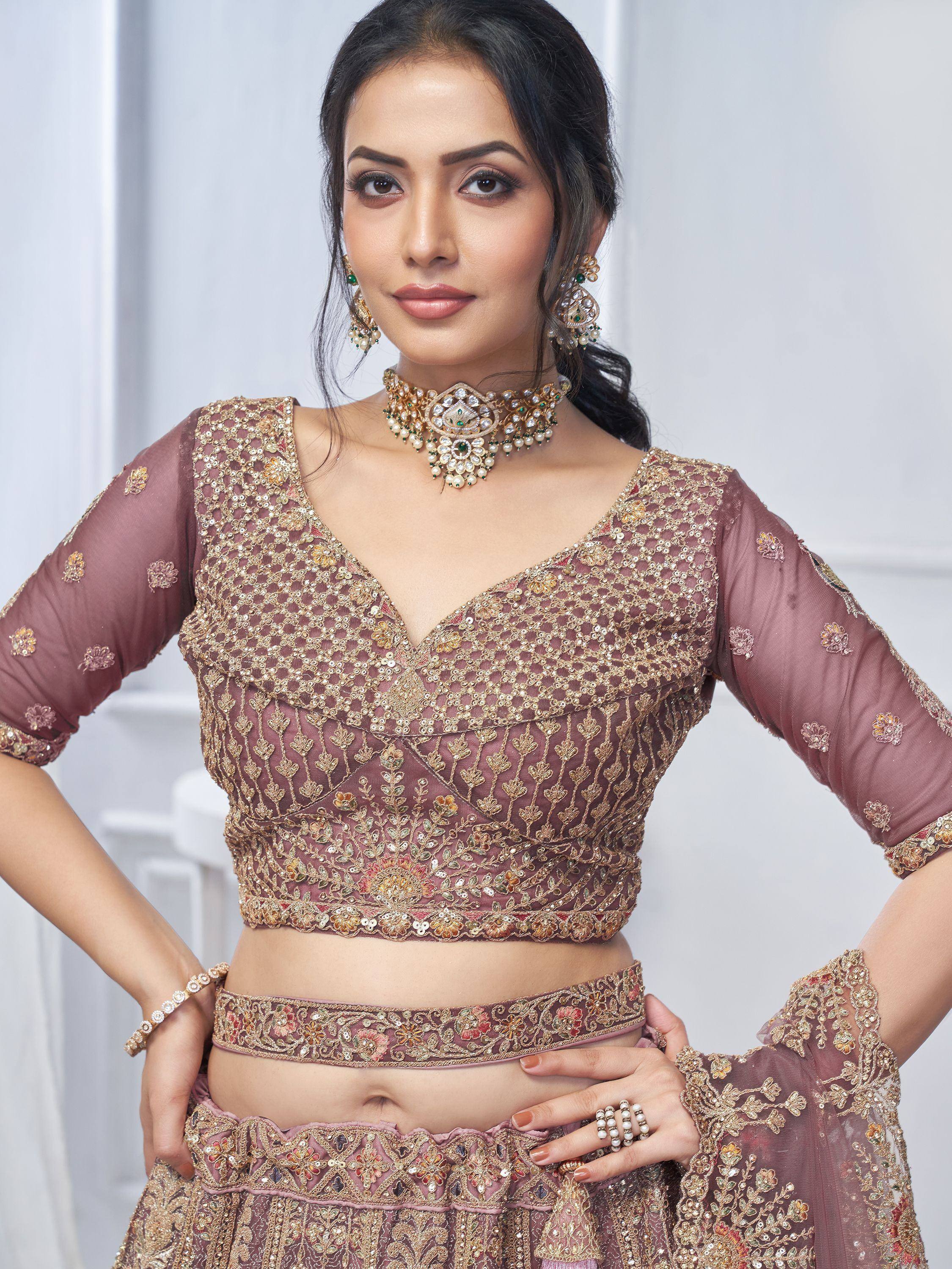 Elegant mauve designer lehenga choli with gold embroidery, perfect for Indian weddings and festive occasions.