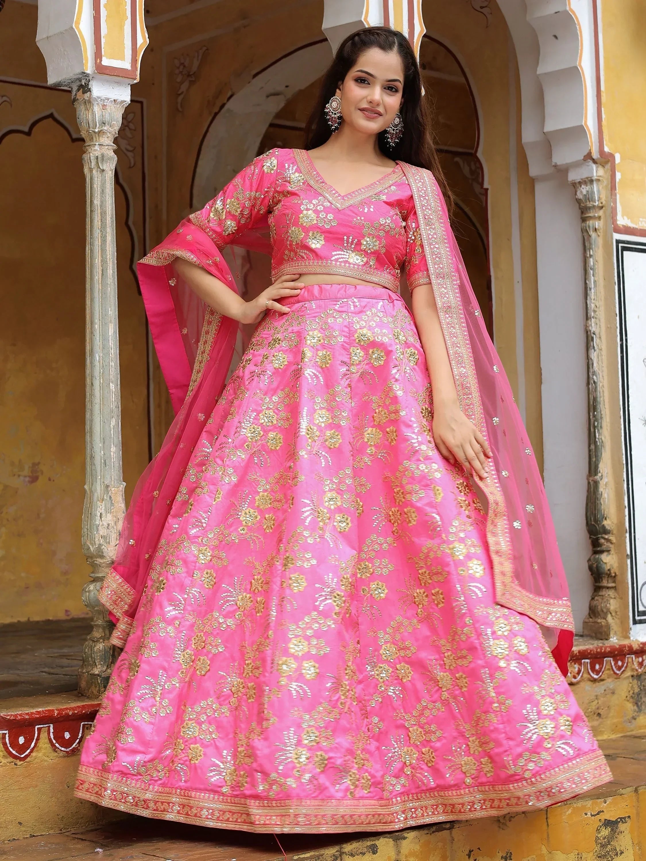 Pink embroidered lehenga choli with gold floral work, perfect for Indian weddings and festive occasions.