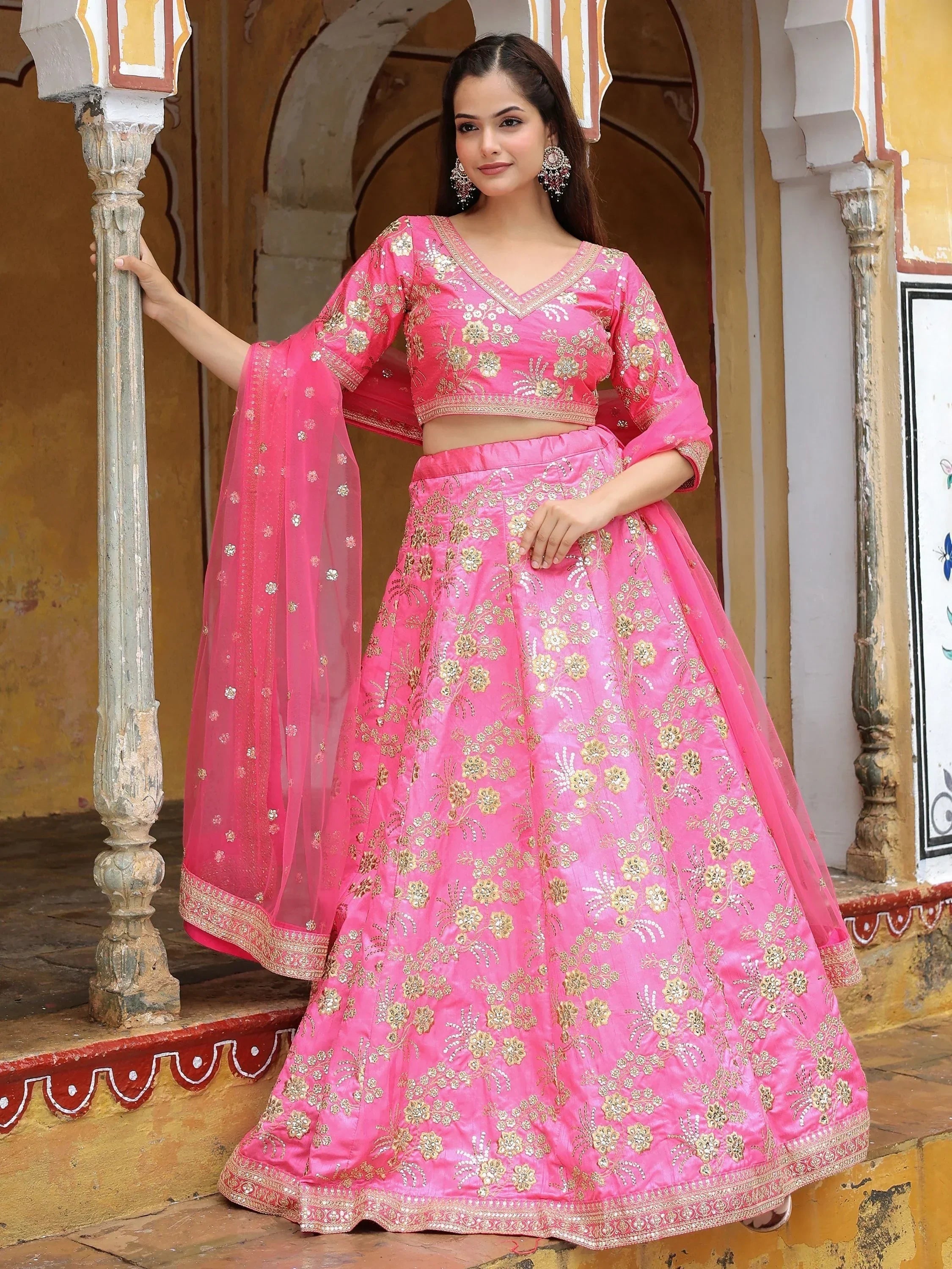 Pink embroidered lehenga choli with gold floral work, perfect for Indian weddings and festive occasions