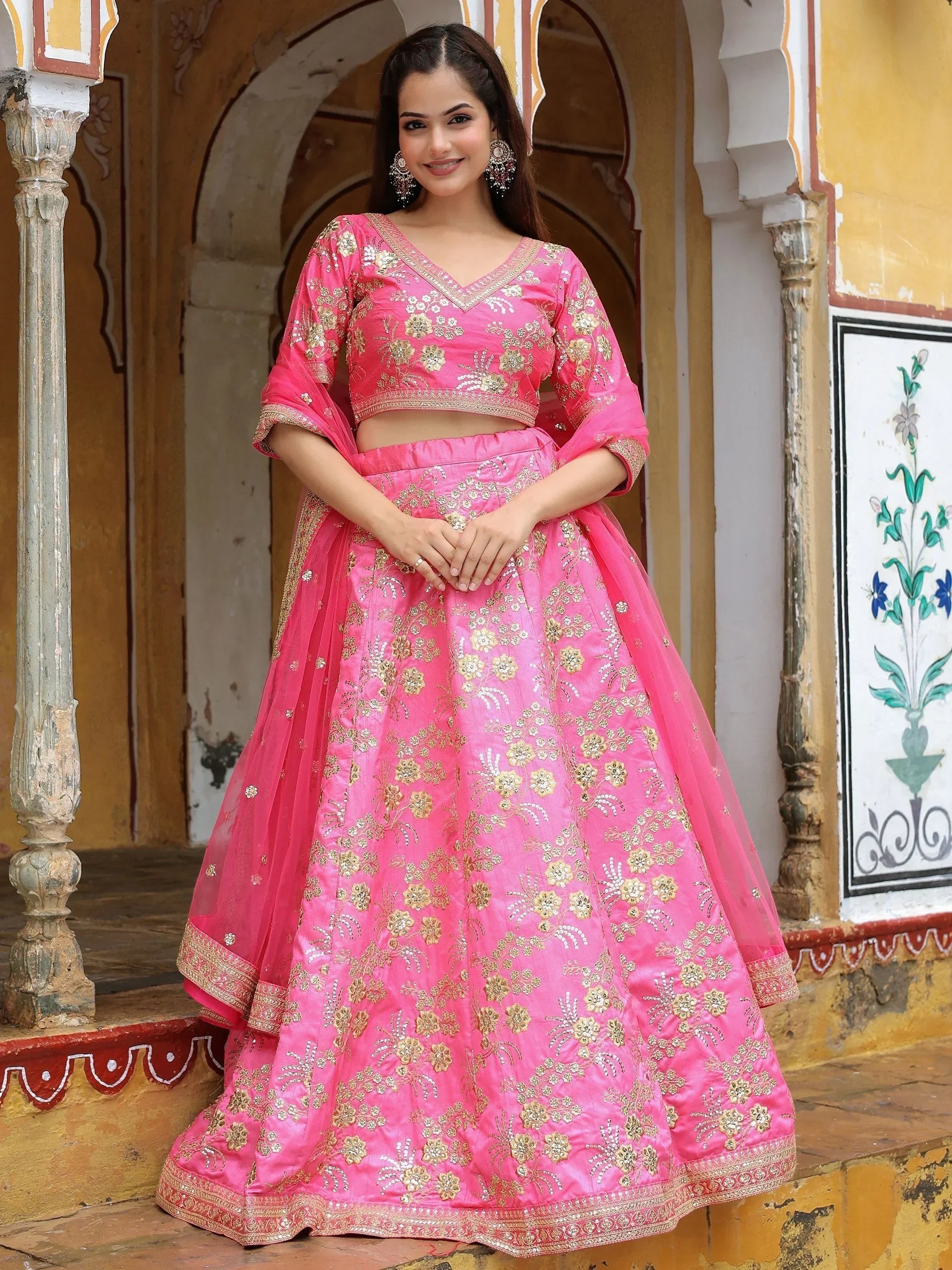 Pink embroidered lehenga choli with gold floral work, perfect for Indian weddings and festive occasions.
