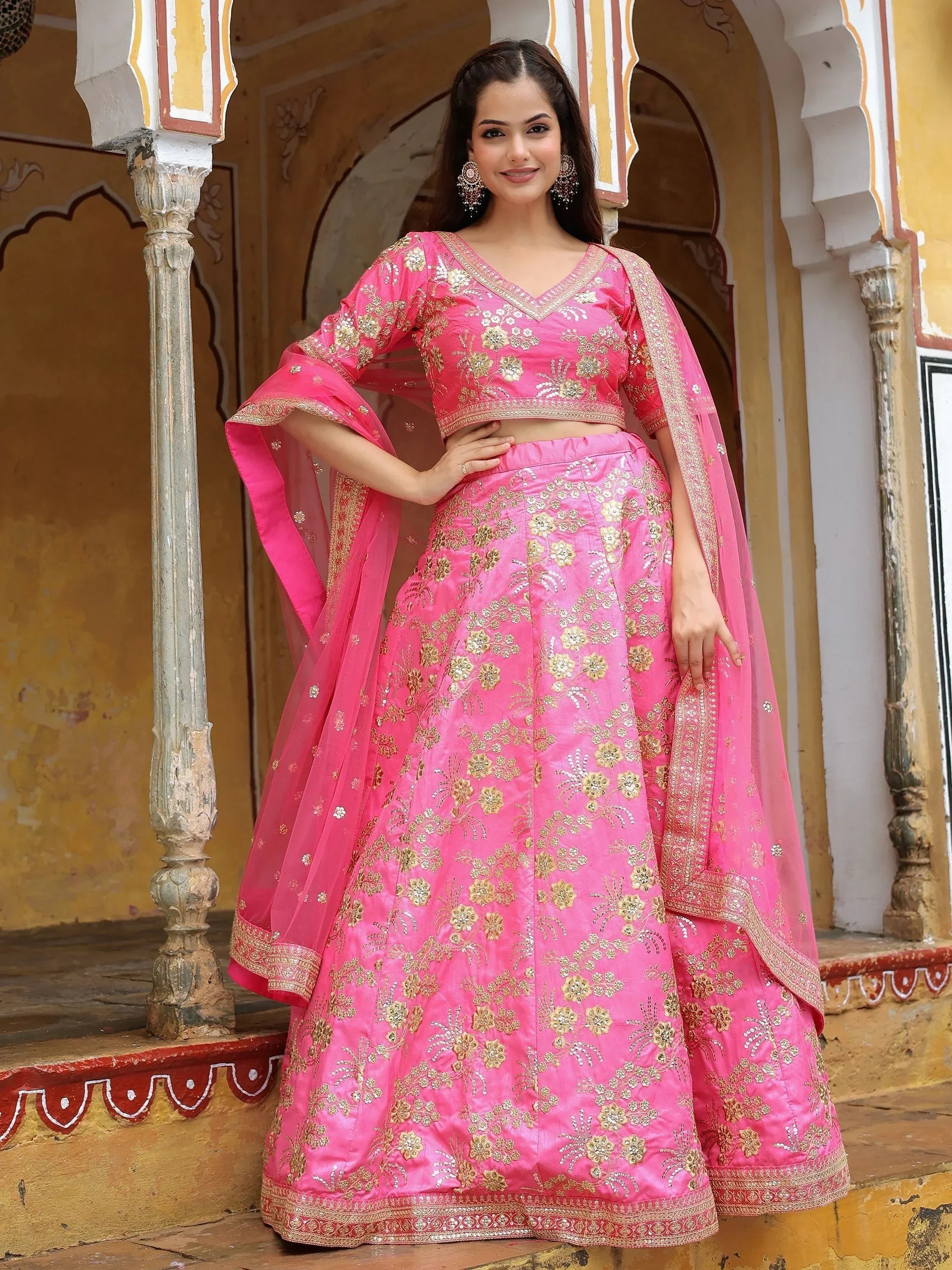 Pink embroidered lehenga choli with gold floral work, perfect for Indian weddings and festive occasions.