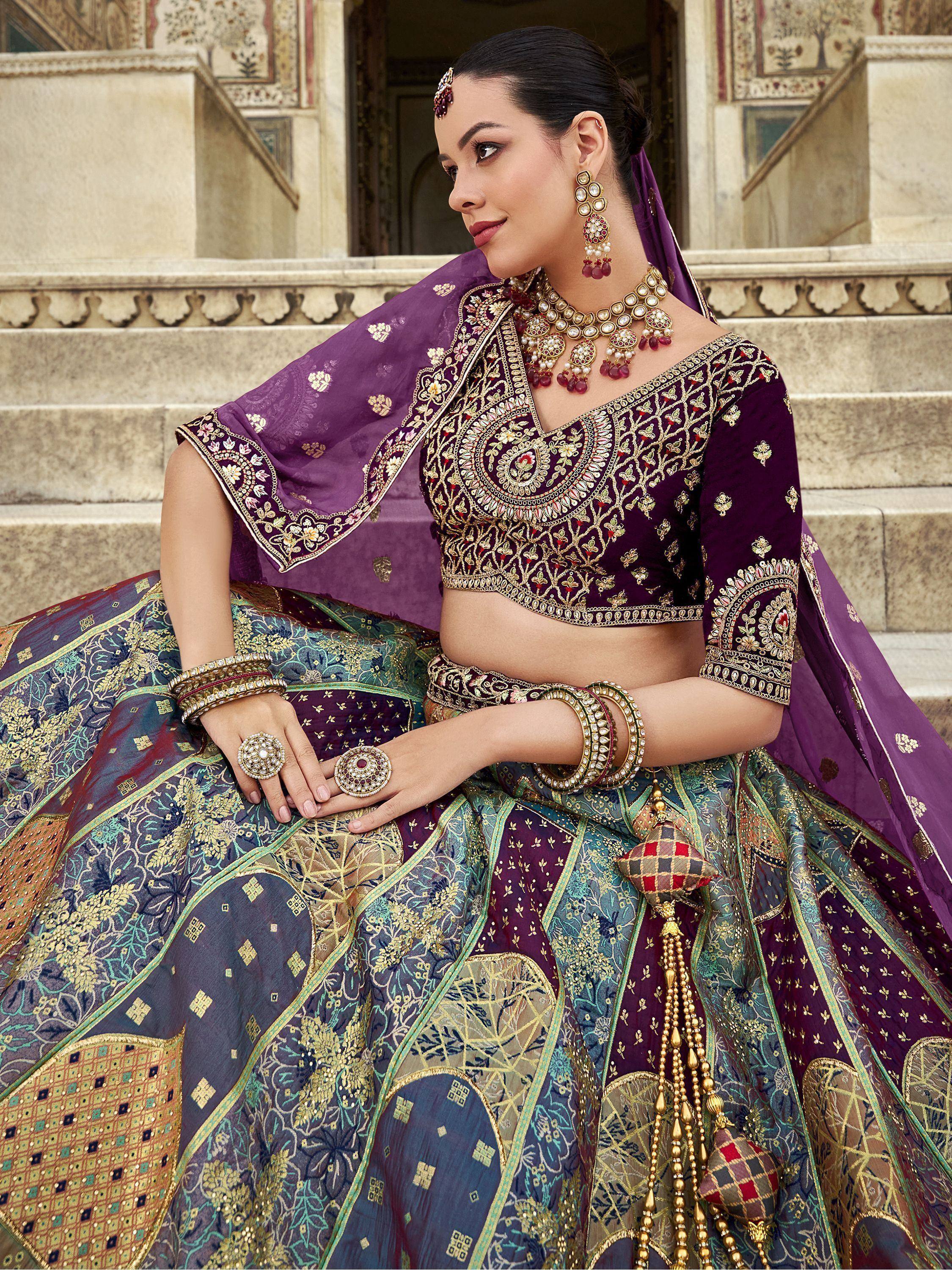Elegant purple and blue embroidered lehenga choli with gold detailing, perfect for Indian weddings and festive occasions.