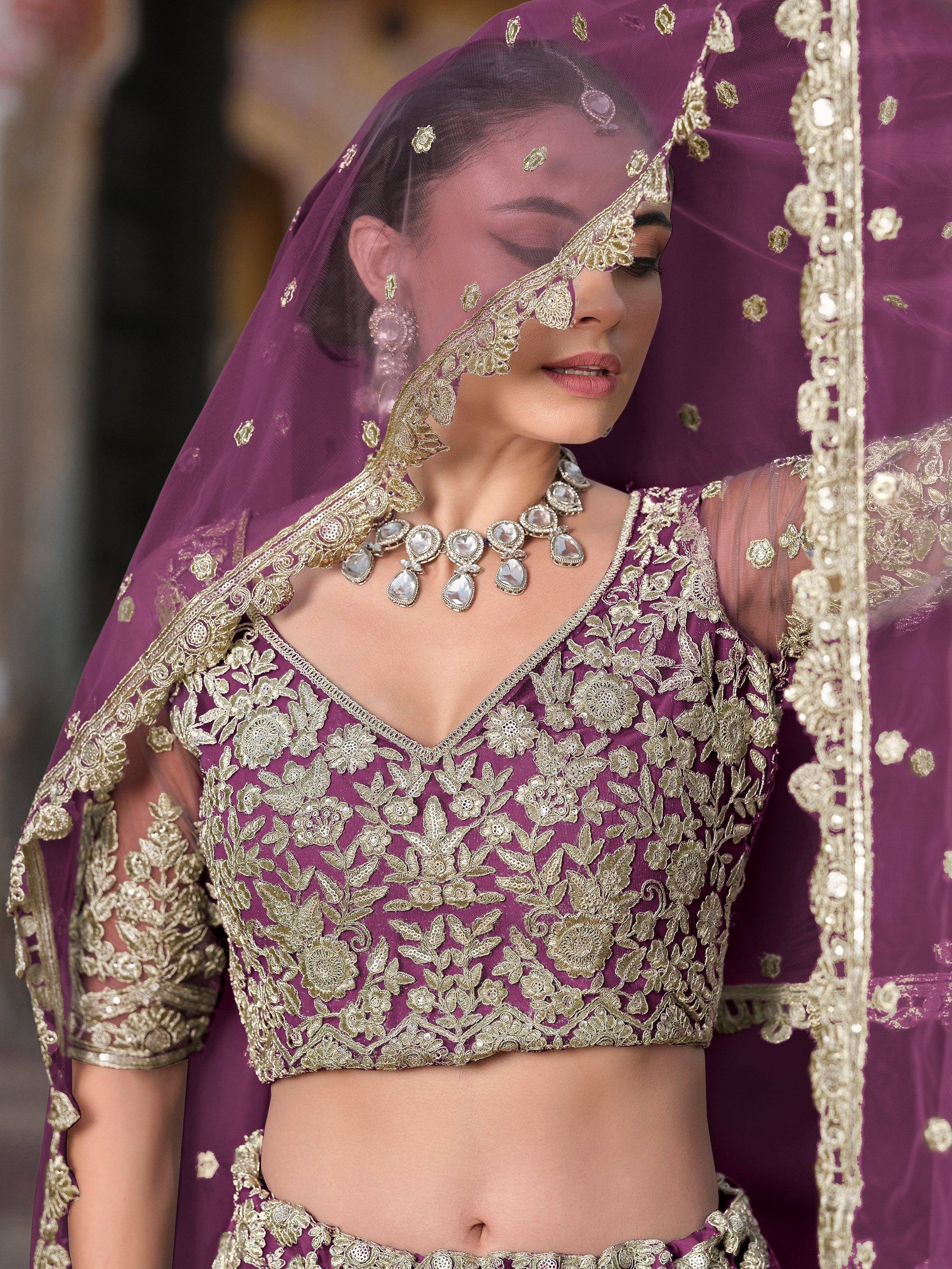 Purple lehenga choli with gold floral embroidery, sheer dupatta, and statement jewelry for Indian weddings