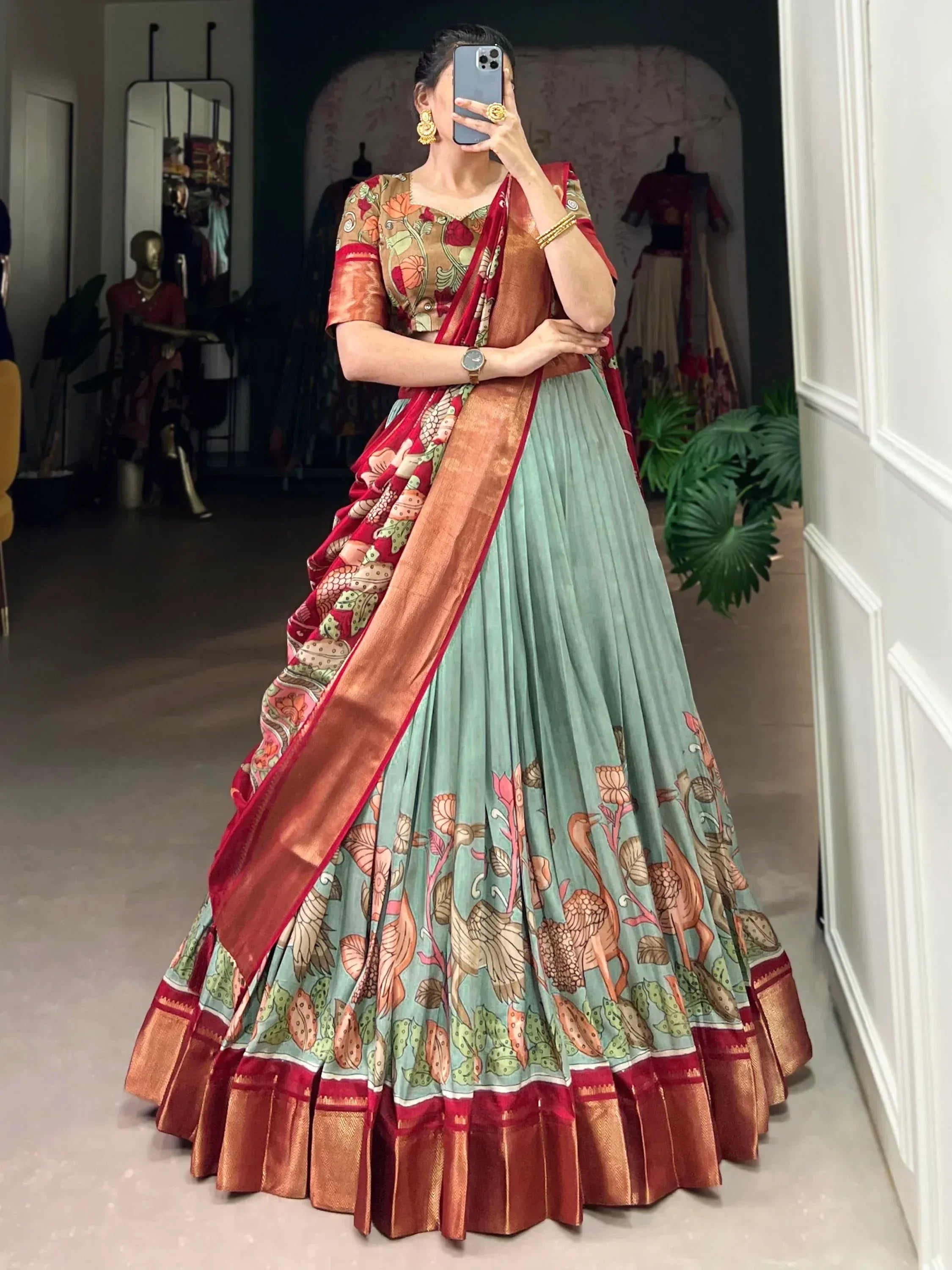 Woman in floral printed lehenga choli with red dupatta, ethnic Indian wear for festive occasions